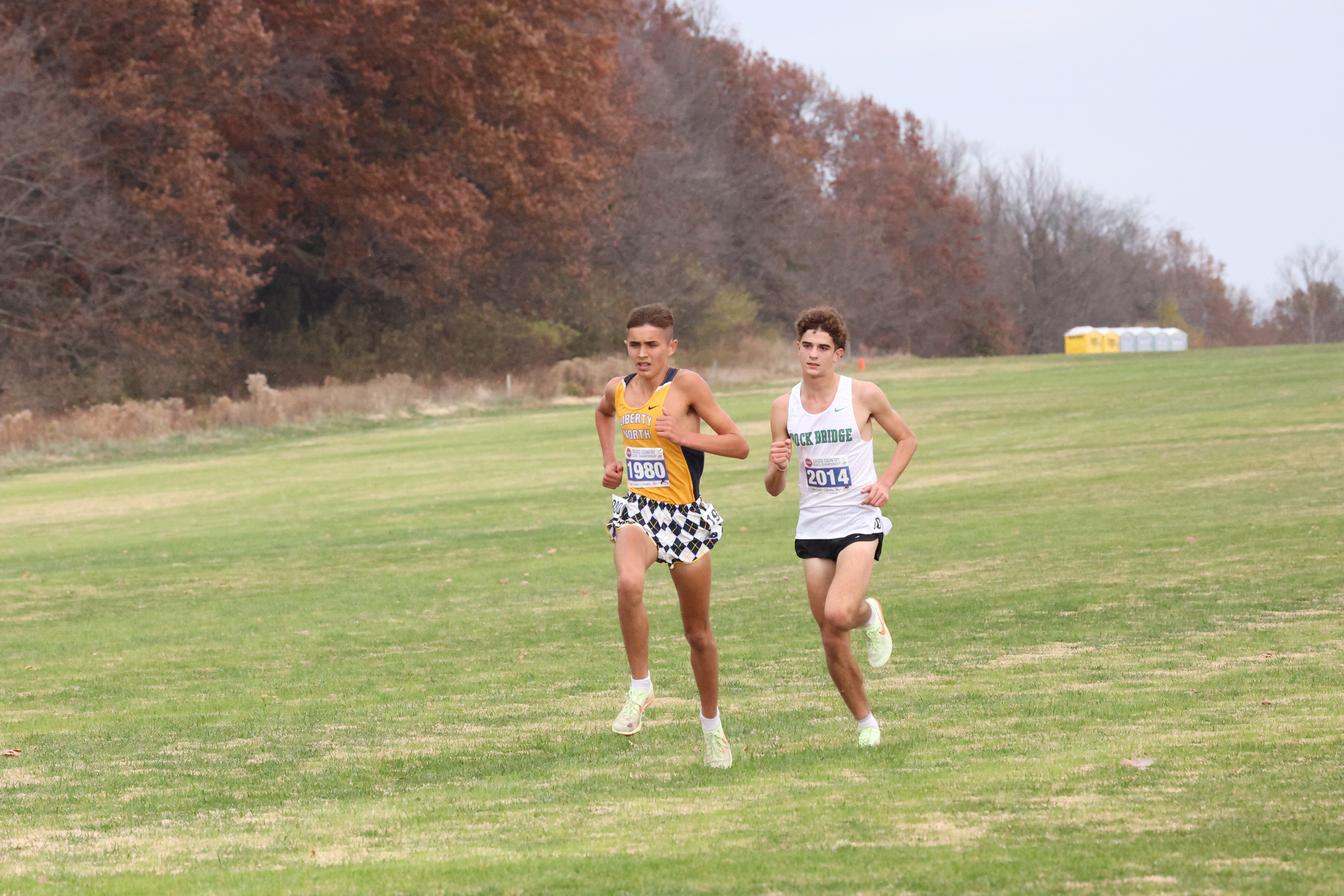 Sage Wilde, left, and Andrew Hauser sprint during the last lap of the Boys Class 5 State 5K race on Friday at Gans Creek. Hauser was on the heels of Wilde for a majority of the race but Wilde ultimately won in 15:05.9. Hauser finished fourth in 15:36.5