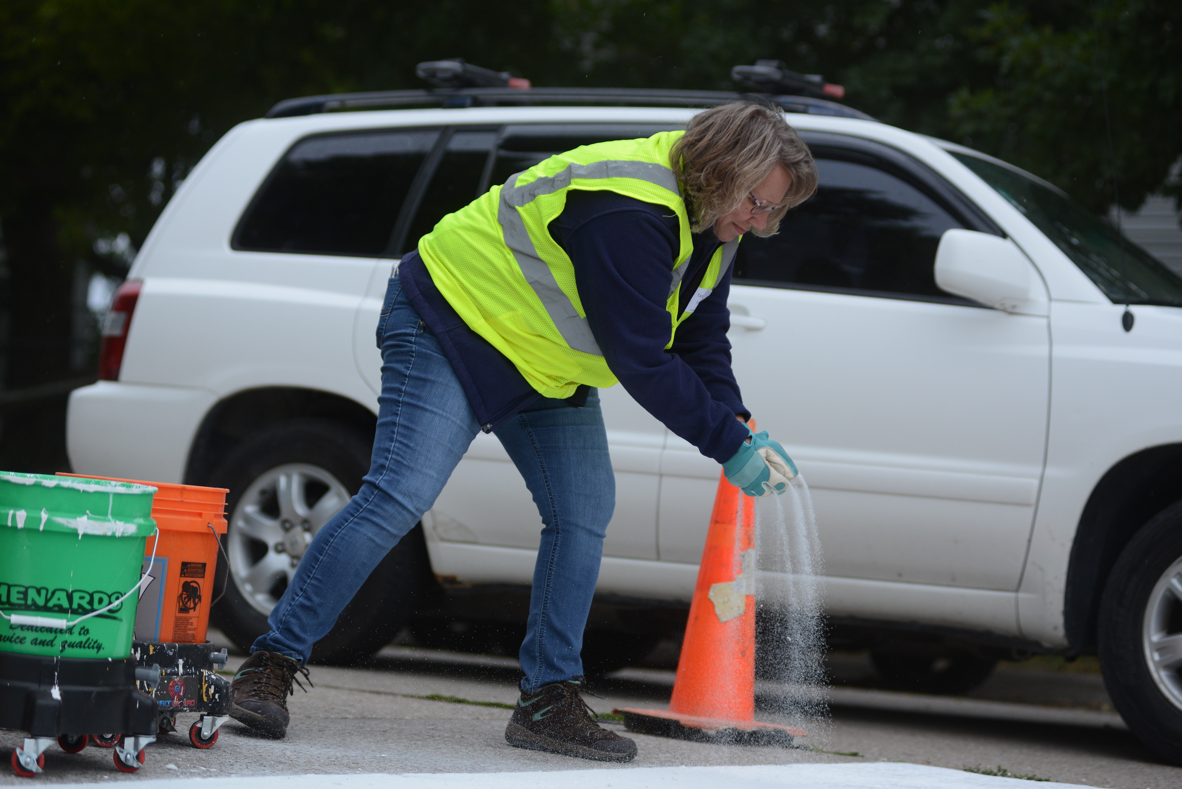 Tammy Irovic, adds the last layer for the newly painted cross walk on Friday, Sept. 23, 2022, at Douglass Park in Columbia. “We had a lot enthusiasm from our staff to do this event again and clearly from their participation we know they were eager and excited about coming out to this neighborhood today,” said Leigh Kottwitz, Neighborhood Services Mangers for the City of Columbia.