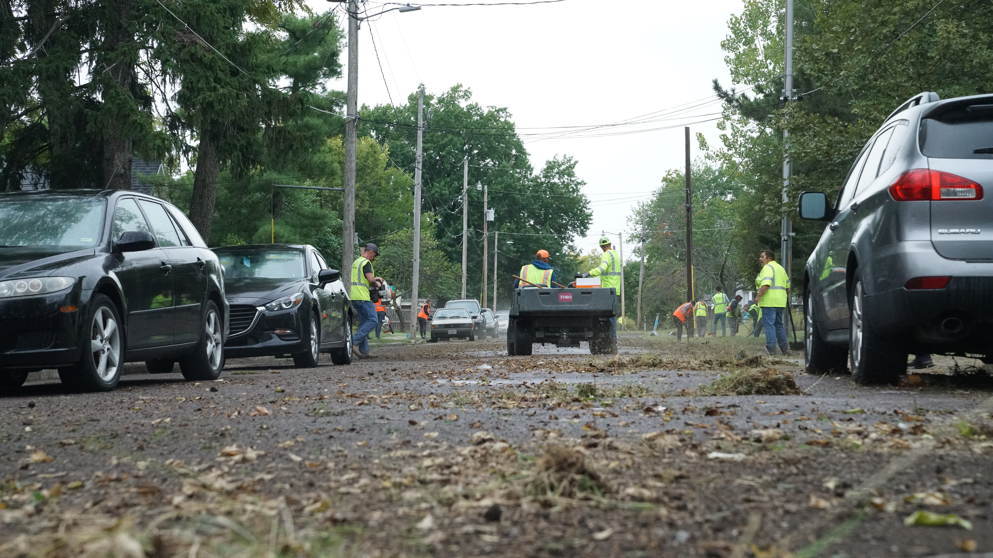 Robert Lambers, right, watches as fellow volunteer crosses the street on Friday, Sept. 23, 2022, at Douglass Park in Columbia.The group completed the cleanup on the Park Avenue side and began work on Lyon Street.