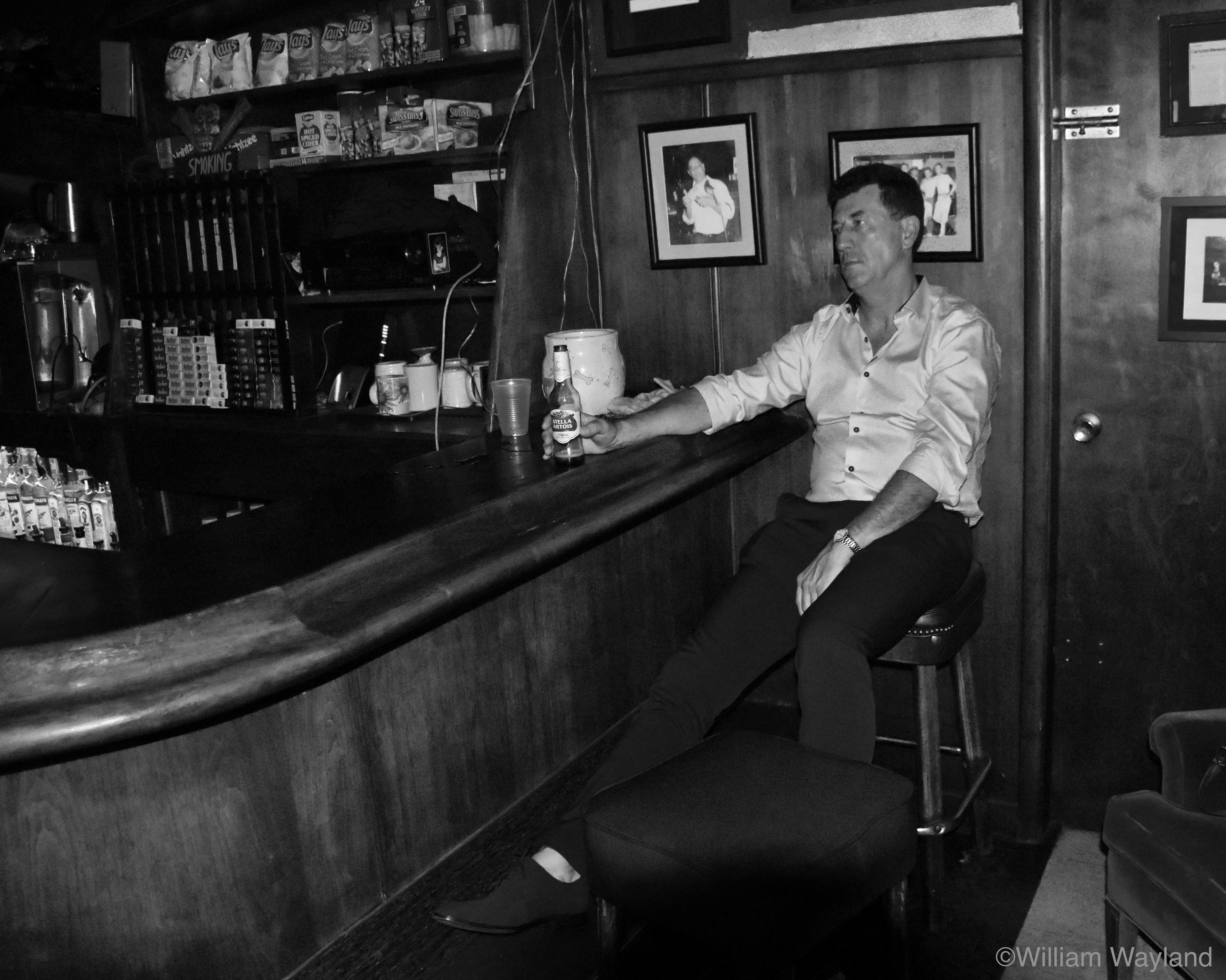 Black and white photograph of man at Peri's Bar in Fairfax by William Wayland