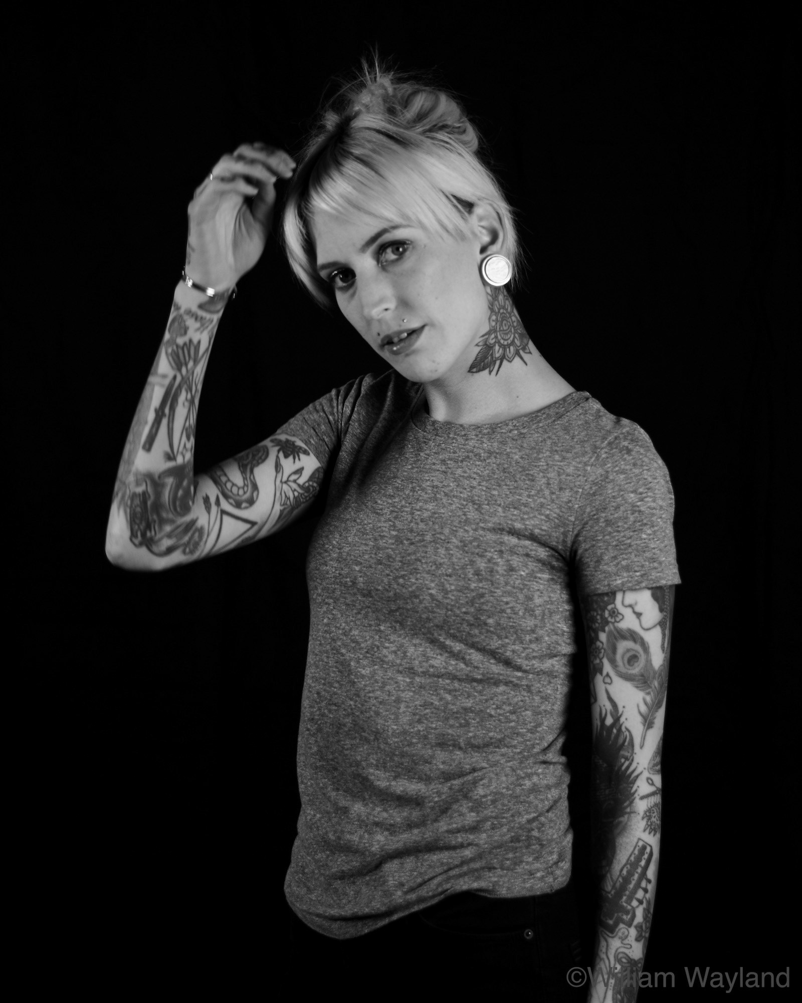 Black and white portrait of a woman with tattoos