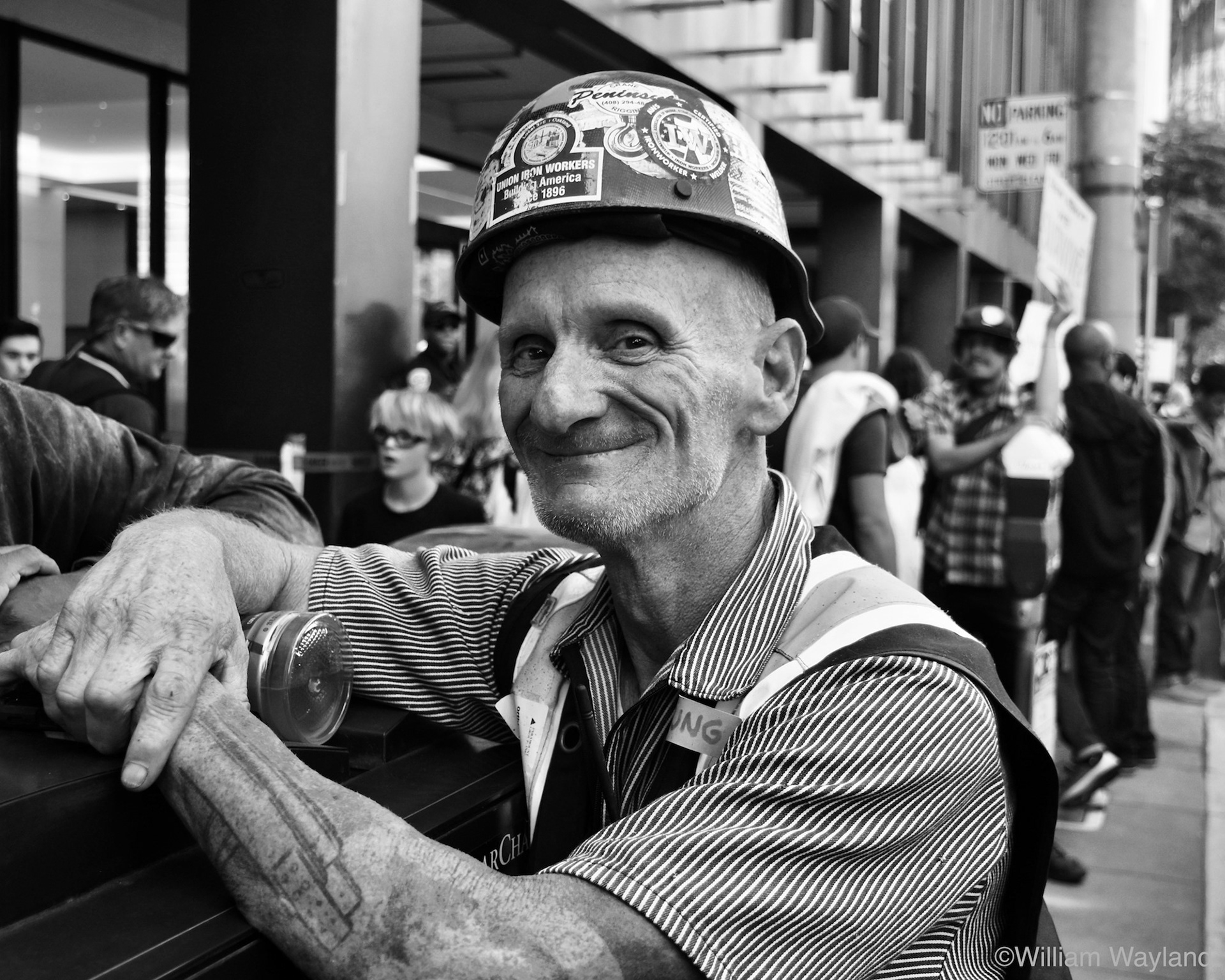 Black and white portrait of an iron worker wearing a hard hat