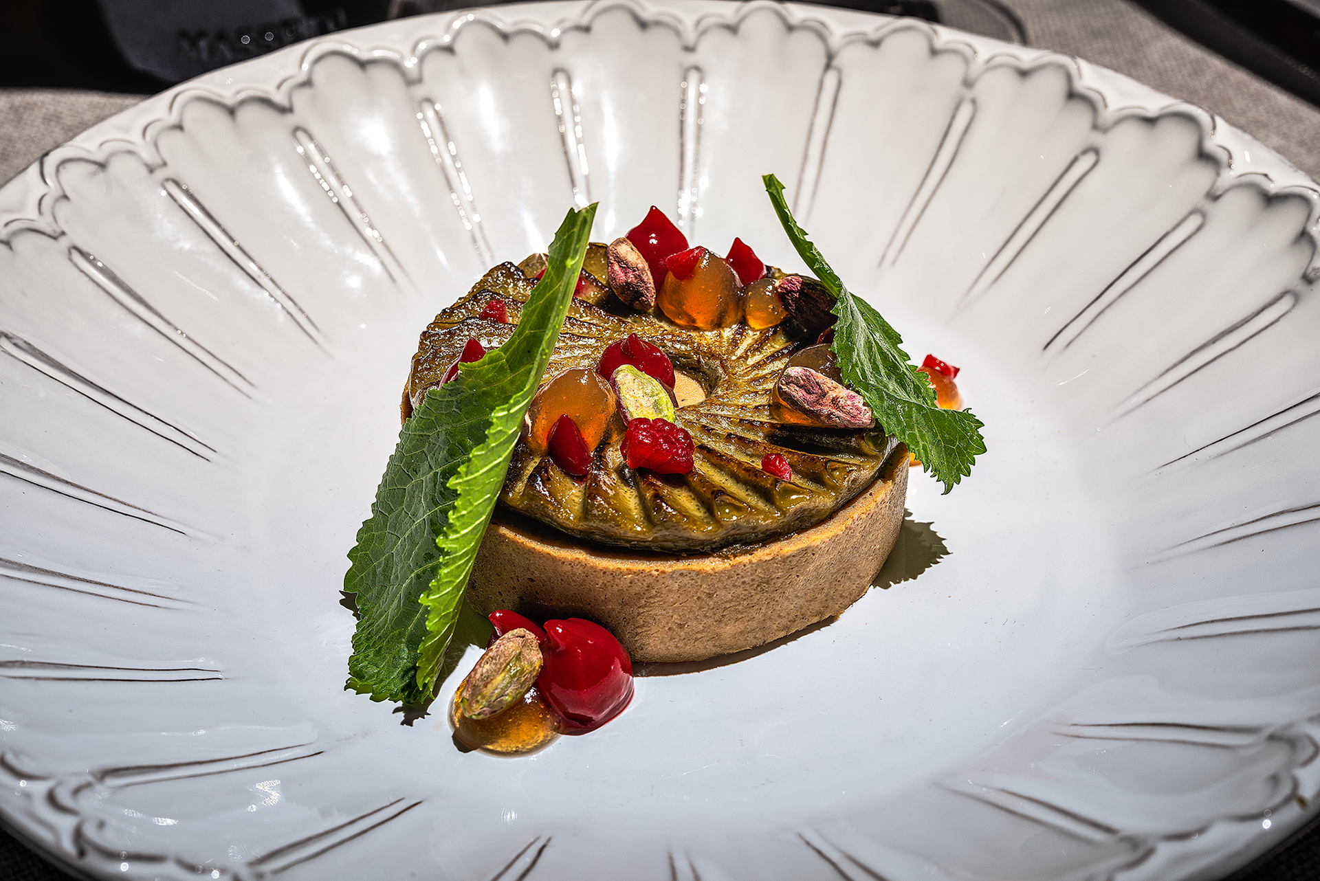 Anatra, creme brùlè al pistacchio, lamponi e stravecchio