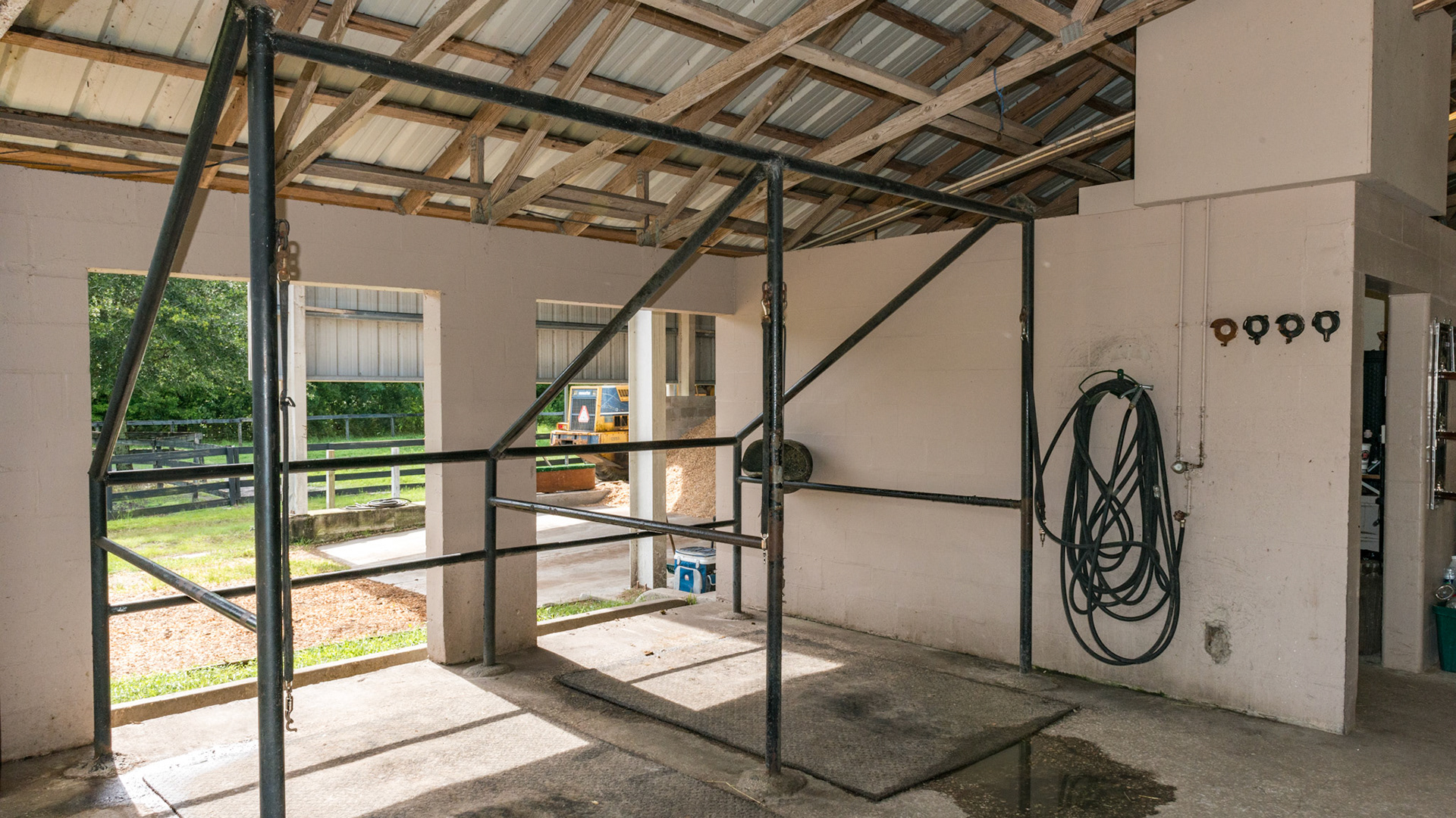 A simple wash rack made of welded steel and anchored in the cement