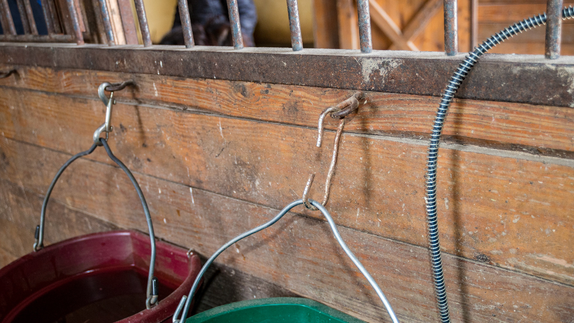 Bucket hooks, the red is correct and the green is incorrect. Also the handle ends on the green one are exposed.