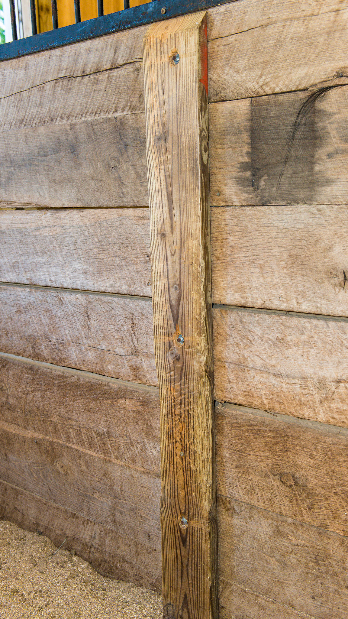 This sandwich board system has good details. The top edge is beveled.  Only 3 carriage bolts are used (good). The bolt shafts are cut level with the board and the nuts are counter-sunk into the wood making this end of the bolt safe against the horse.