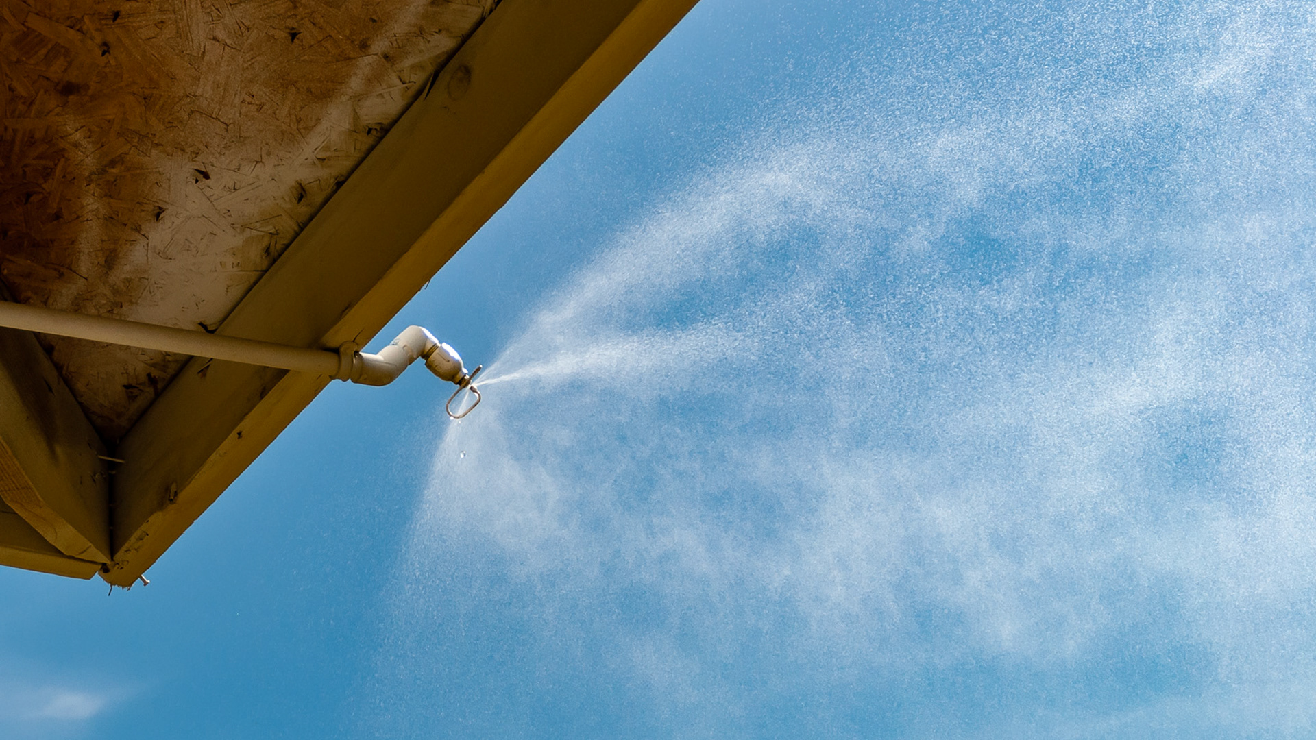 Misting plumbing attached to the roof of an outdoor shed in Florida