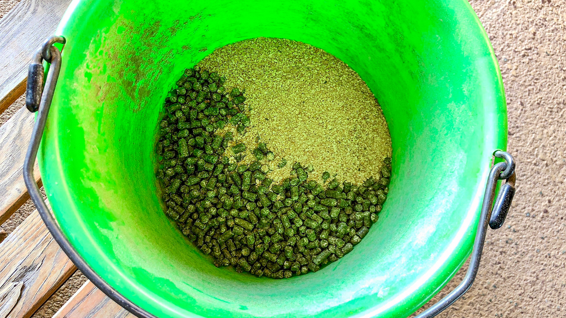 Soy bean meal and alfalfa pellets in a pail.