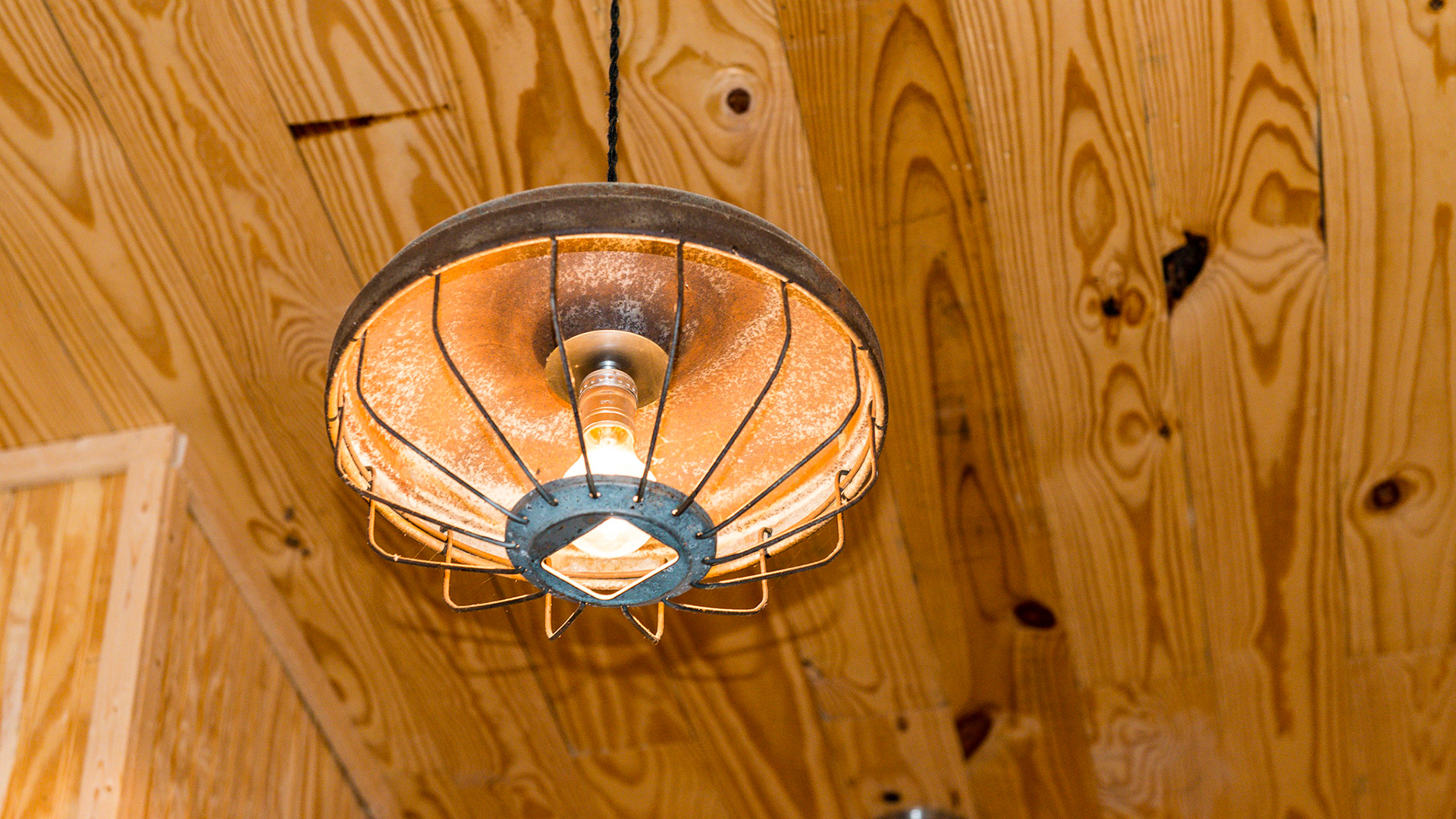 These ceiling lights in a tack room are made from old chicken feeders.