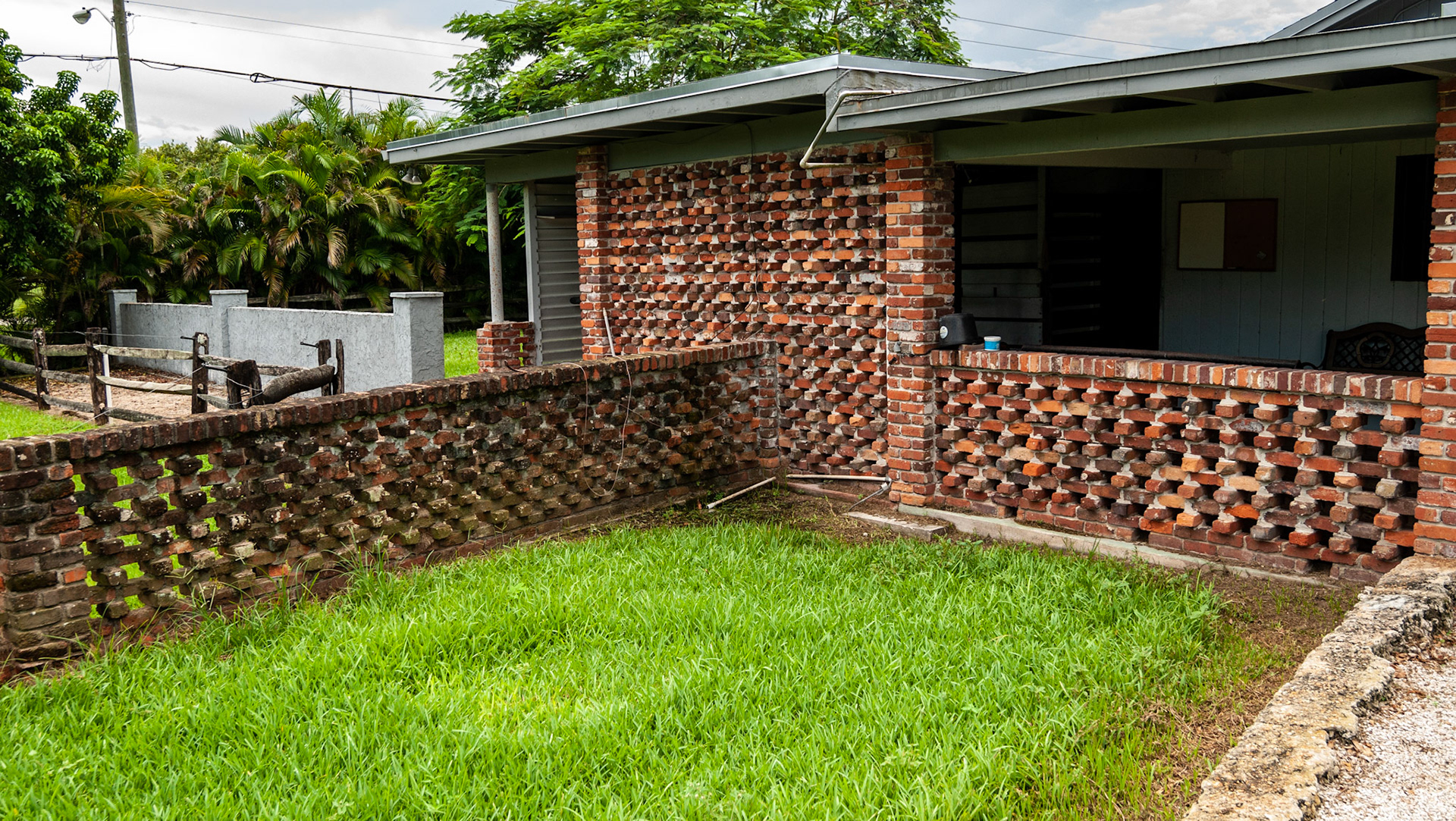 A decorative fence made of brick in south Florida - but the horses were turned out behind it as it doubled as a paddock fence.  The wash rack is behind the tall brick wall.