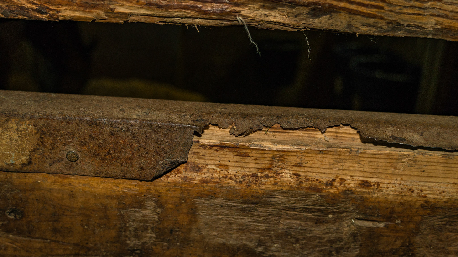 Rusted out galvanized metal on stall walls