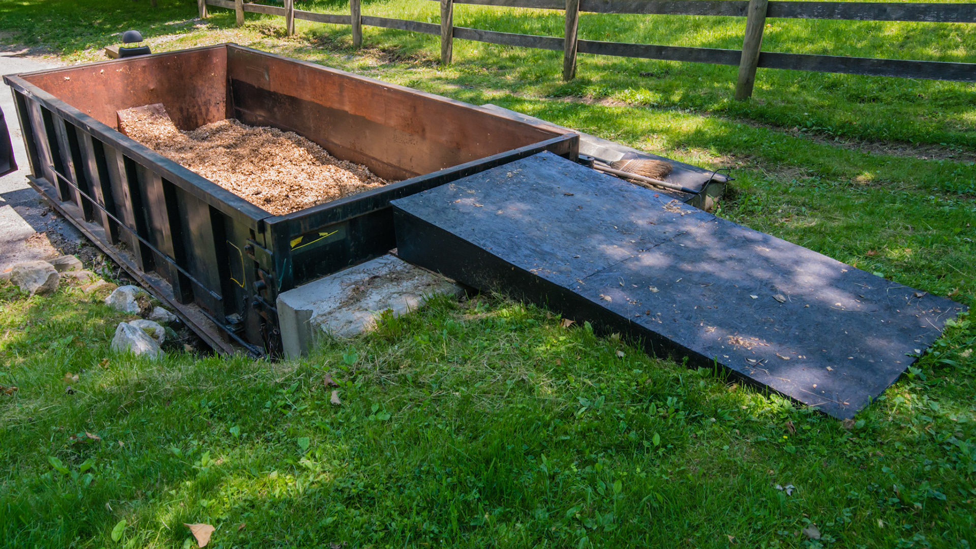 Roll off container for manure. Notch dug in hillside and lined with cement blocks and loading ramp level with top edge. 3 of 3