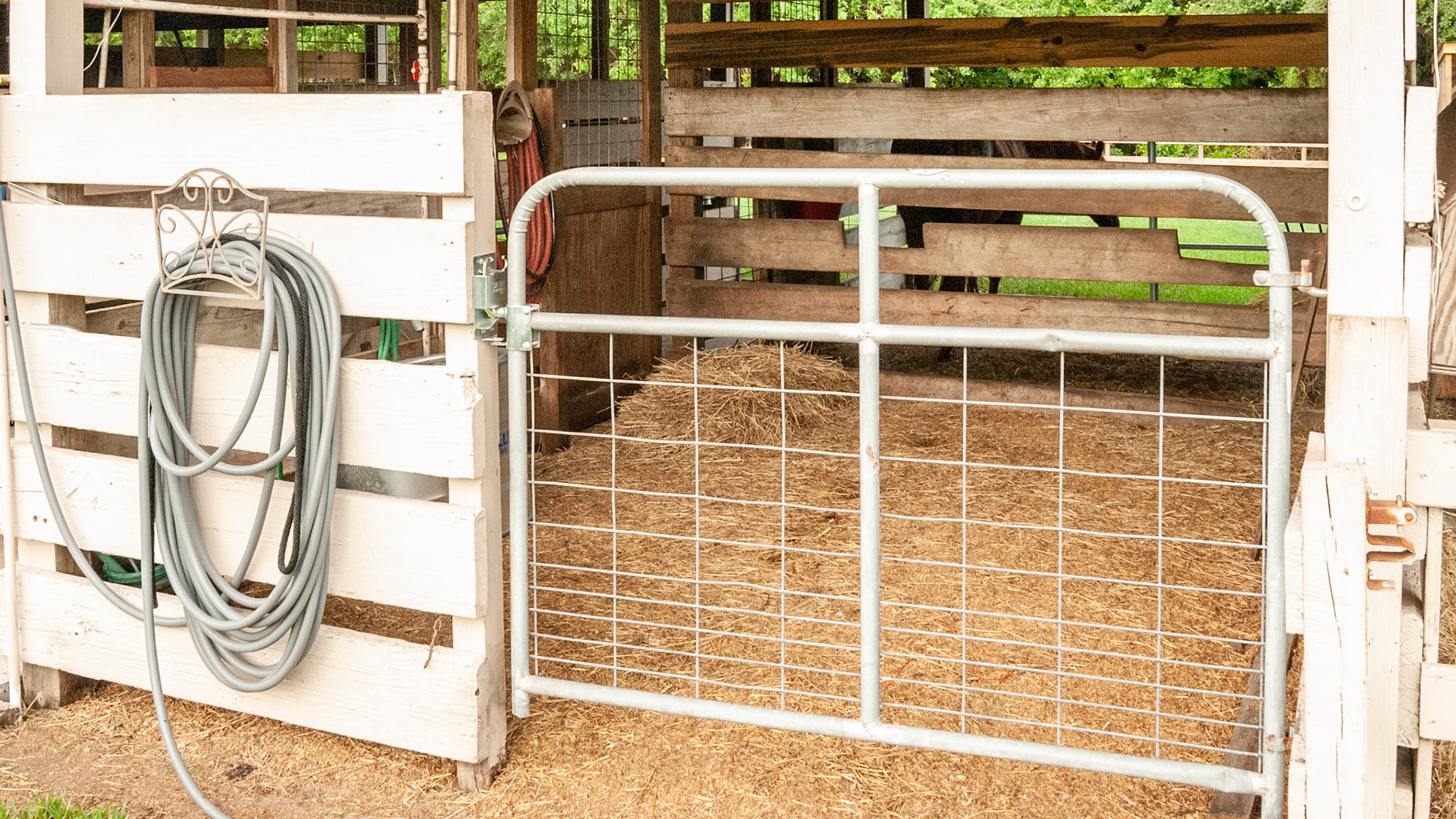 Automatic closing latch mechanism allowing the gate to swing either way.  Difficult for the horse to open.