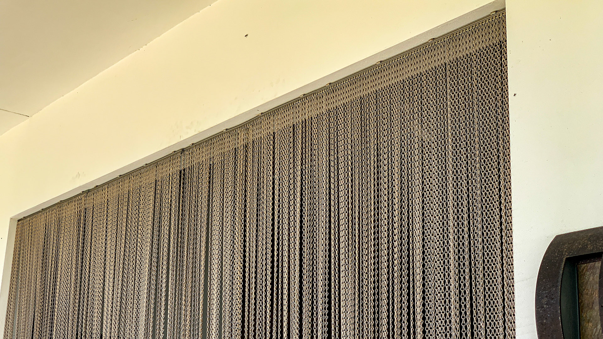 A curtain of chain effectively keeps the flies out of this barn.