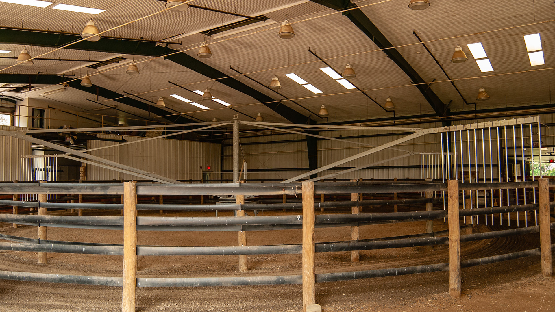 Indoor arena with a hot walker installed.