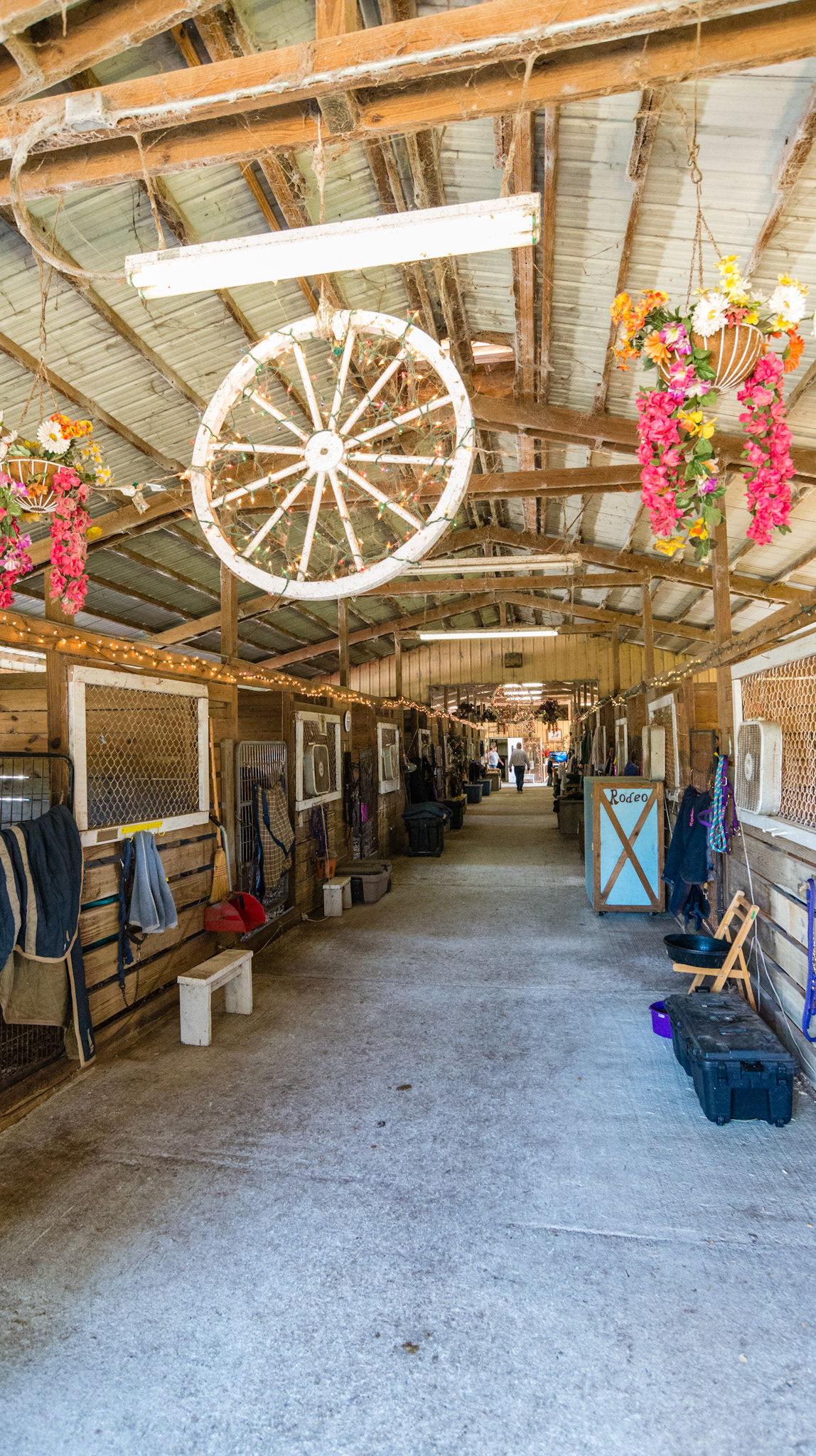 Decorating a barn. Lights, wagon wheel, and flowers.