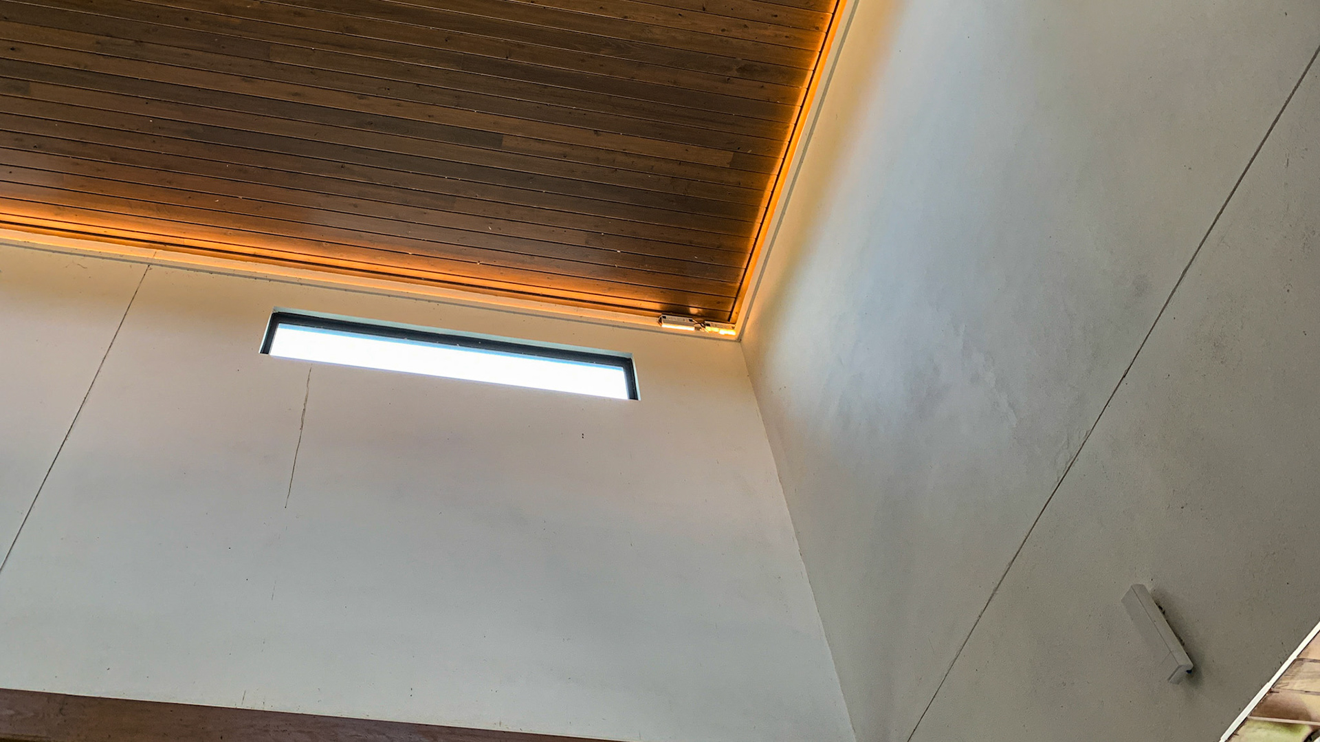 LED accent lightings lines the ceiling between the ceiling and the vertical walls that remain on during daylight.  I bet they look nice as night as well as adding light to inspect but not much to affect the sleep of the horses.