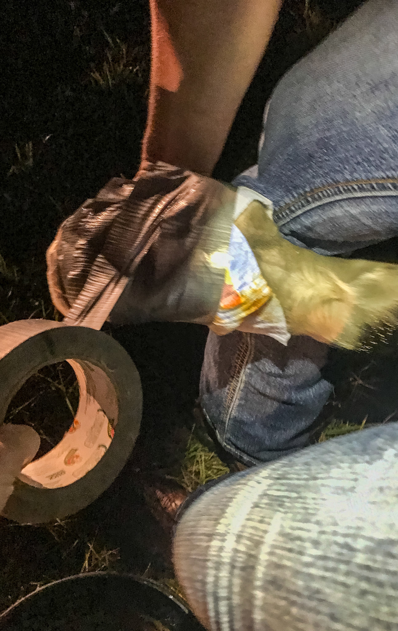 Wrapping a hoof with a diaper and duct tape.