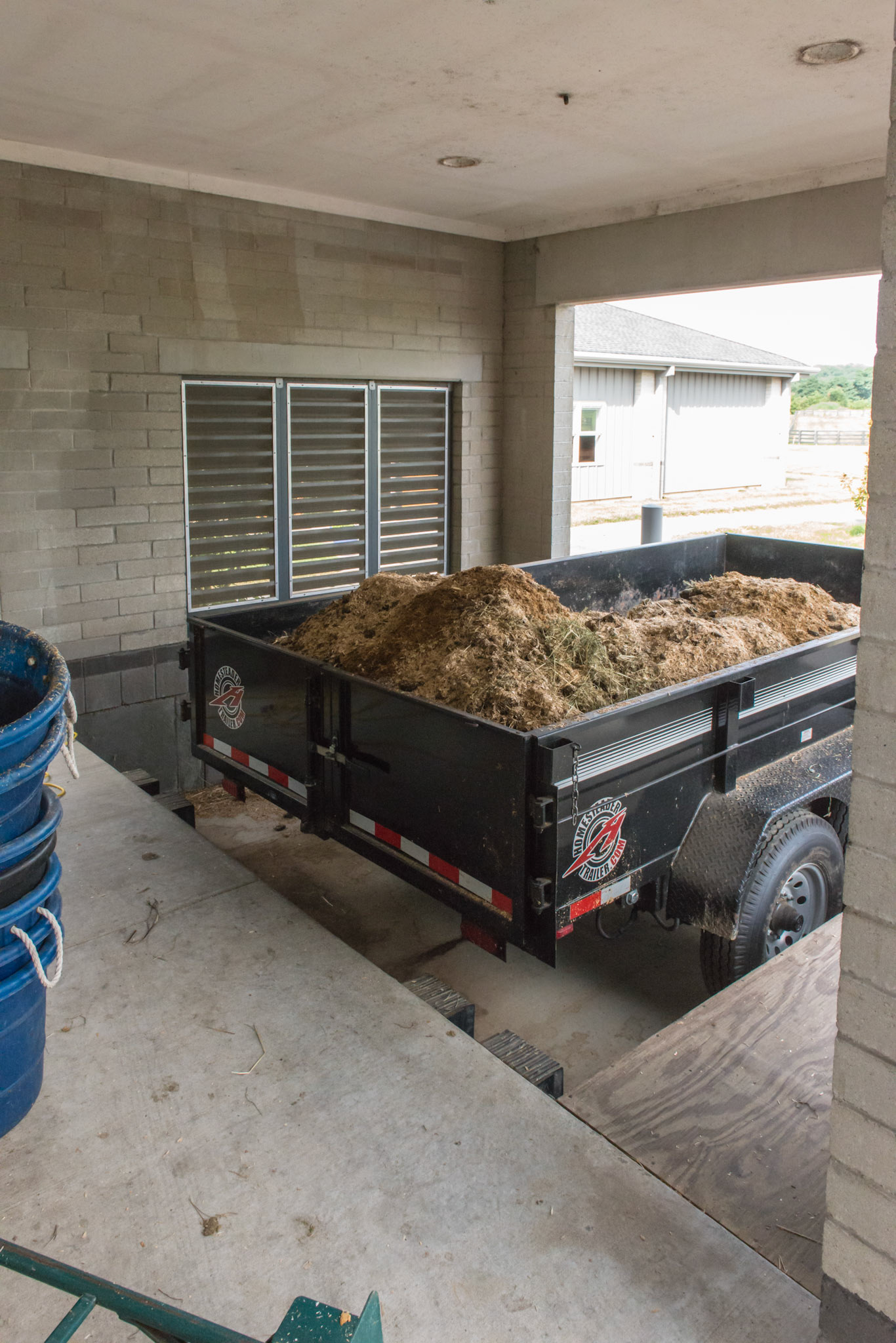 A covered loading dock for manure loading of the dump wagon. The tailgate drops to the level of the dock allowing easy and safe access to people. 2 of 2