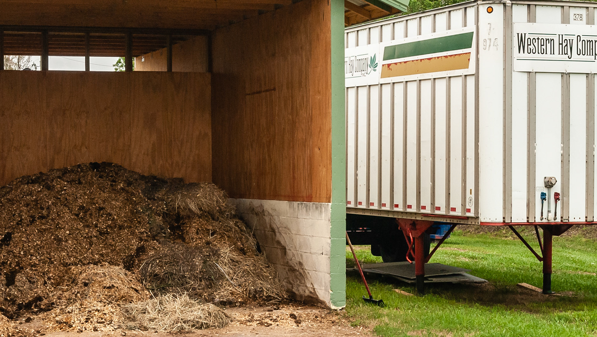Waste is contained in this shed and hay is kept in the semi trailer next to it and rotated out with each delivery.