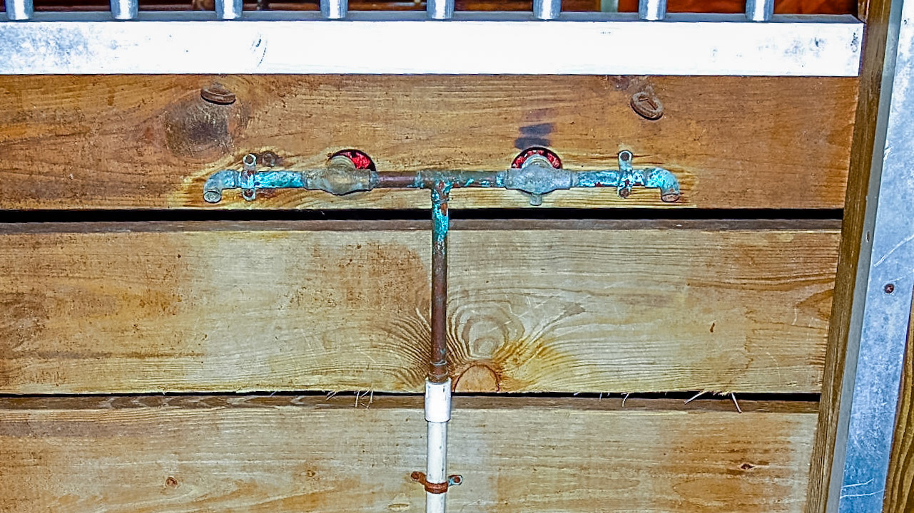 Pipes inside the stall and the valves are outside