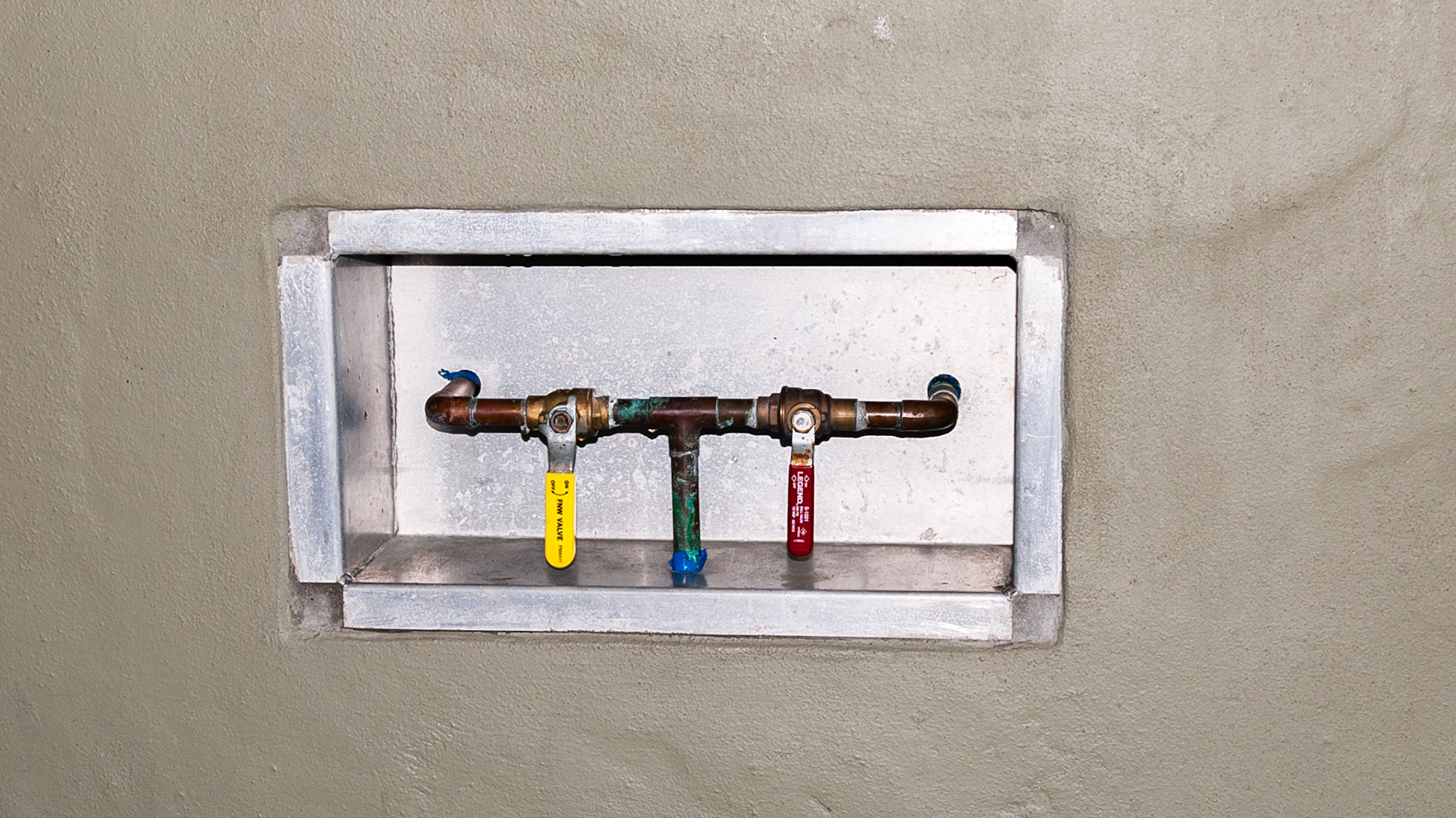 Recessed handles control water flow into individual buckets inside the stall.