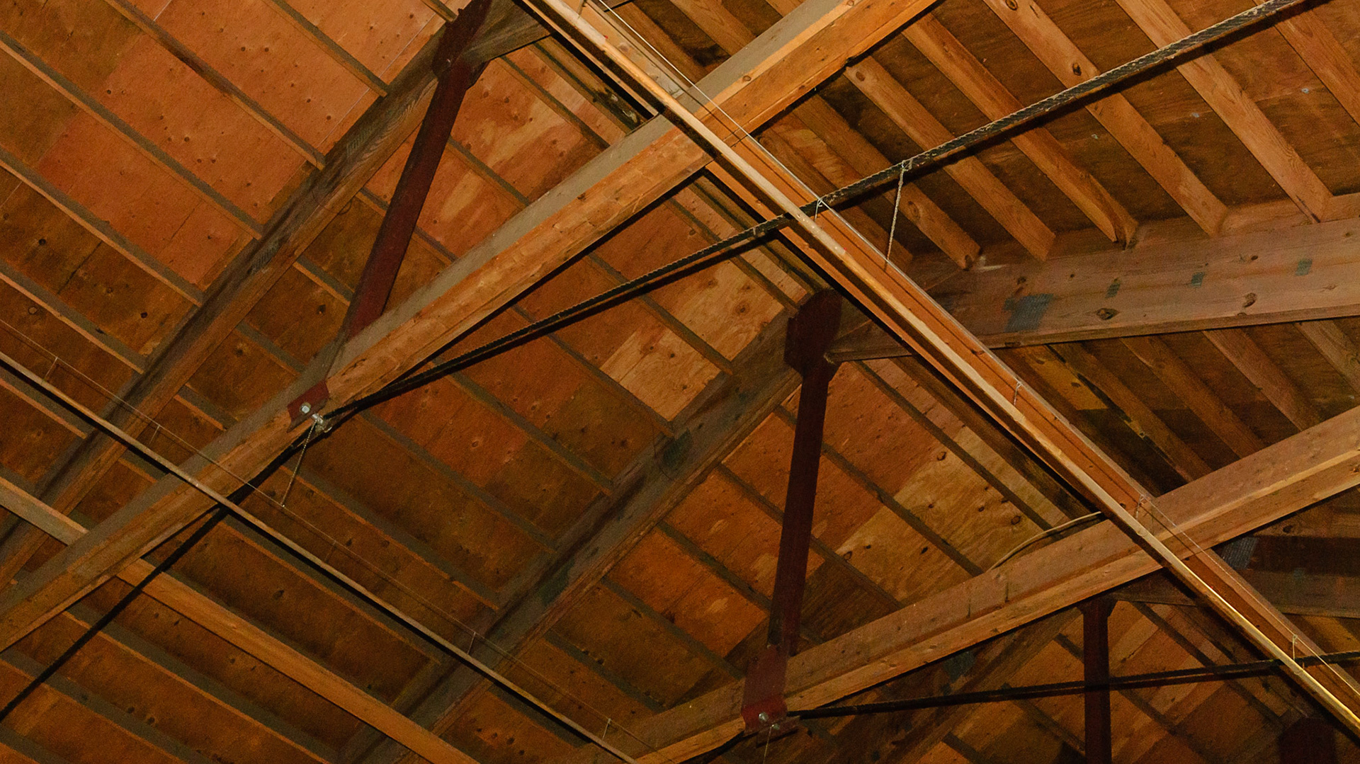 Custom made metal truss braces.  Cabling applied to prevent spread of the walls due to a snow load.