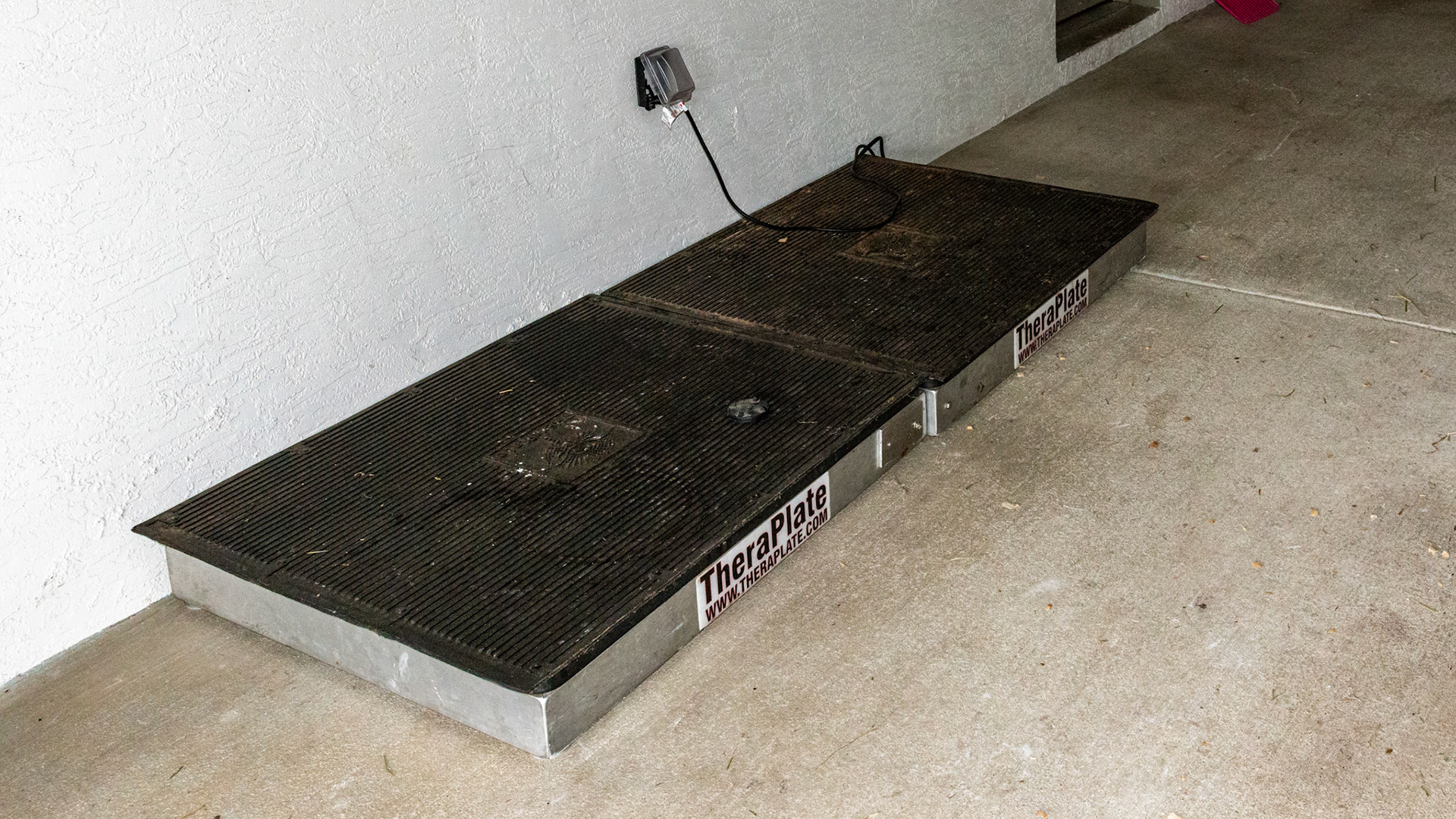 A vibration plate for horses.  Note where the outlet is for the unit makes it an obstacle as well as a danger for the horse standing on the wire.  In addition, without containment, horses have been known to fall off the edge of these plates. Adding a platform surrounding the plate would make this unit more safe and effective.