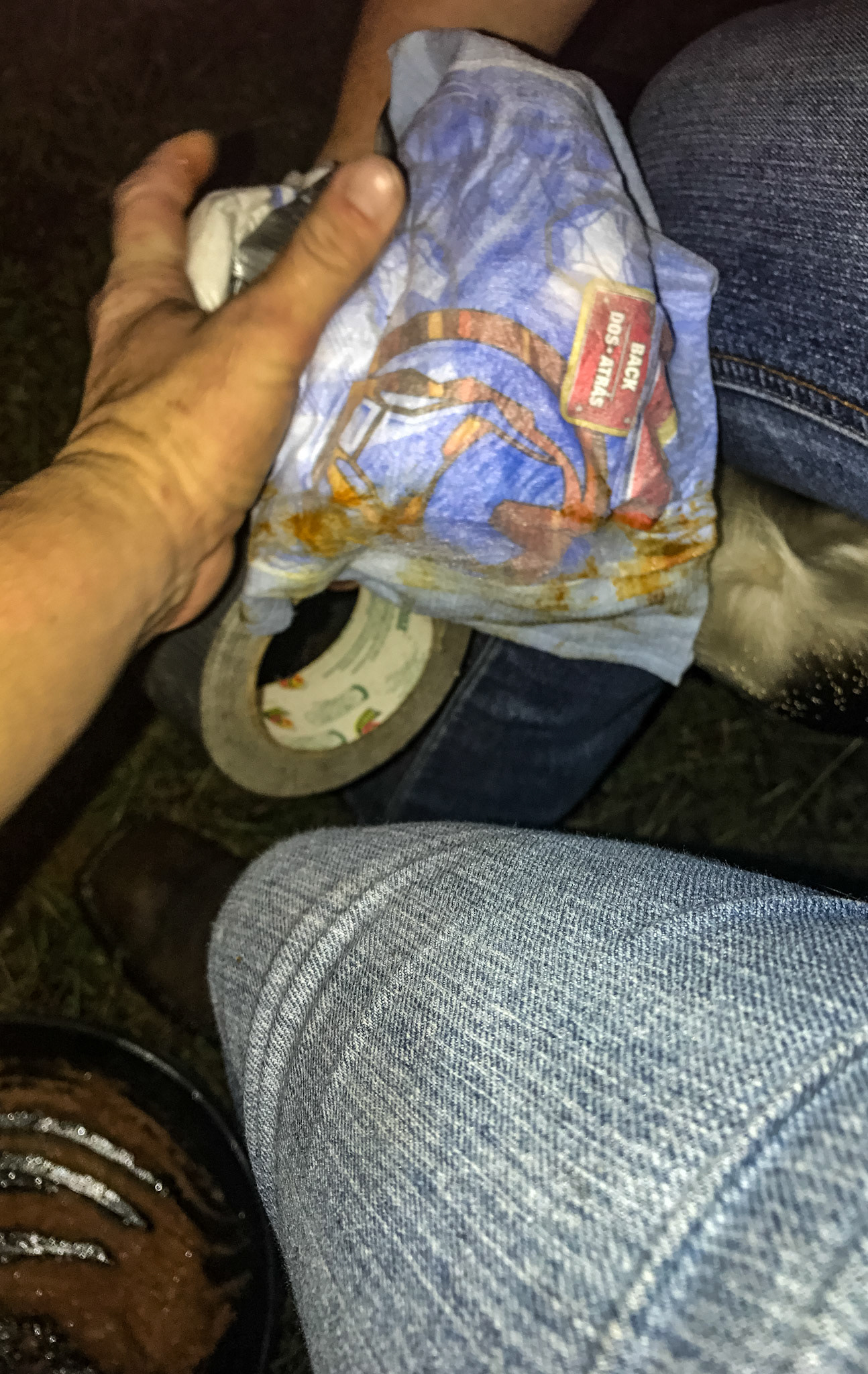 Wrapping a hoof with a diaper and duct tape.