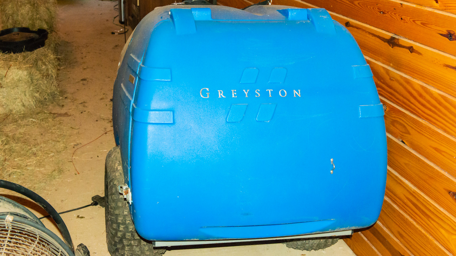 The Greyston manure vaccuum is pulled with a small riding tractor. A large diameter hose is attached to the hole next to the engine. While driving through the paddock, the end of the hose is directed over a manure pile and sucked into the blue container.  Manure can then be composted and used on the garden.
