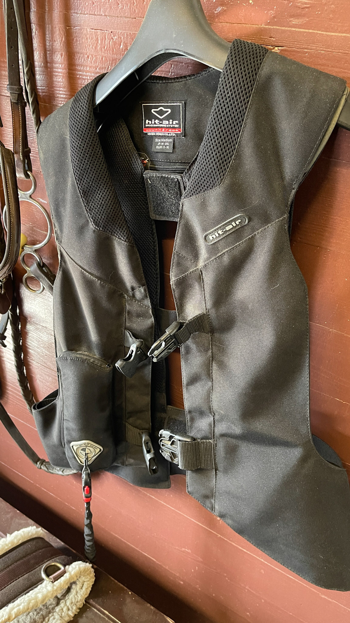 Inflatable safety riding vest. Lanyard attaches to the horse and activates a CO2 tank for instant inflation.