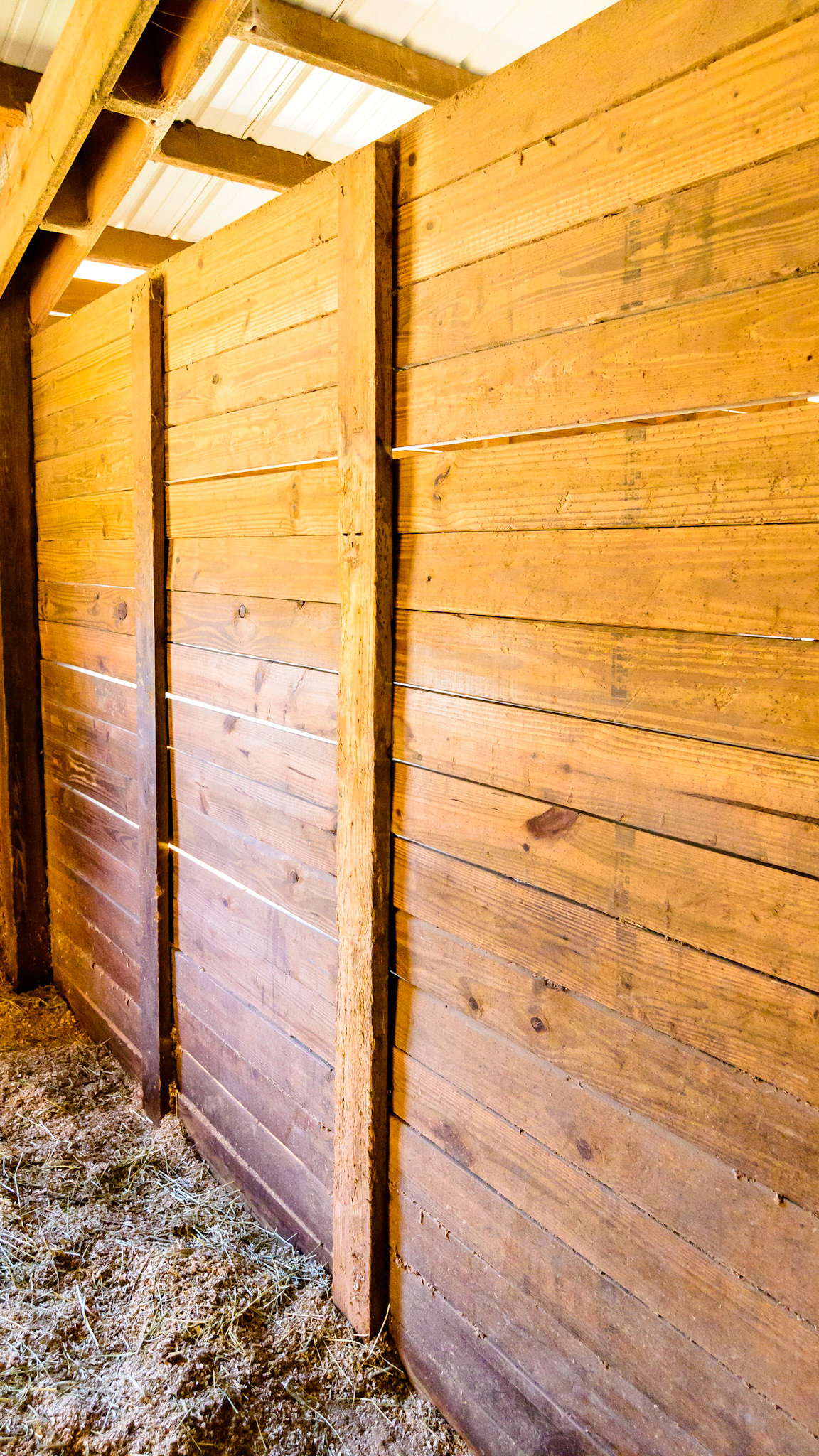 Boards only on one side using nails that are allowing some of the stall boards to back out. While effective in preventing bowing of the stall boards it is not a long lasting solution.