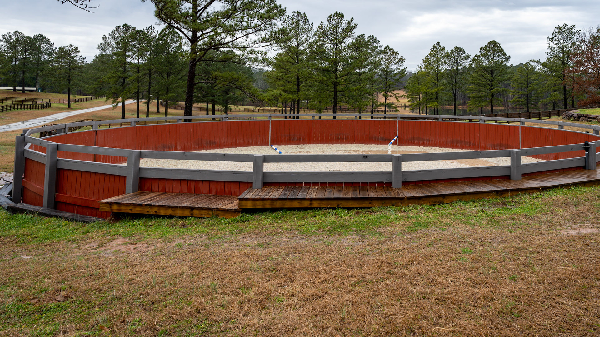 Various views of a round pen built into a hillside.