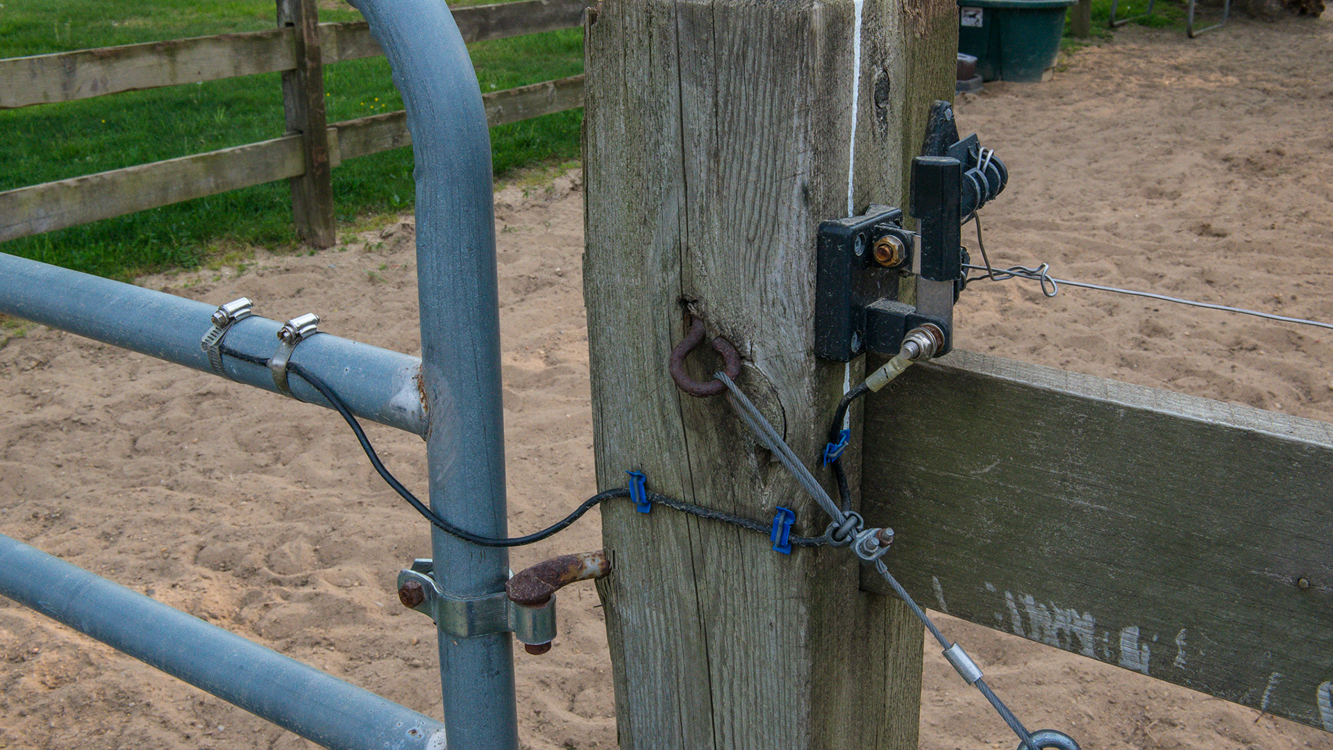 An electrified gate prevents the horse from using his hooves to paw at the gate and damage it.  A knife switch is used to disconnect the power for gate use.