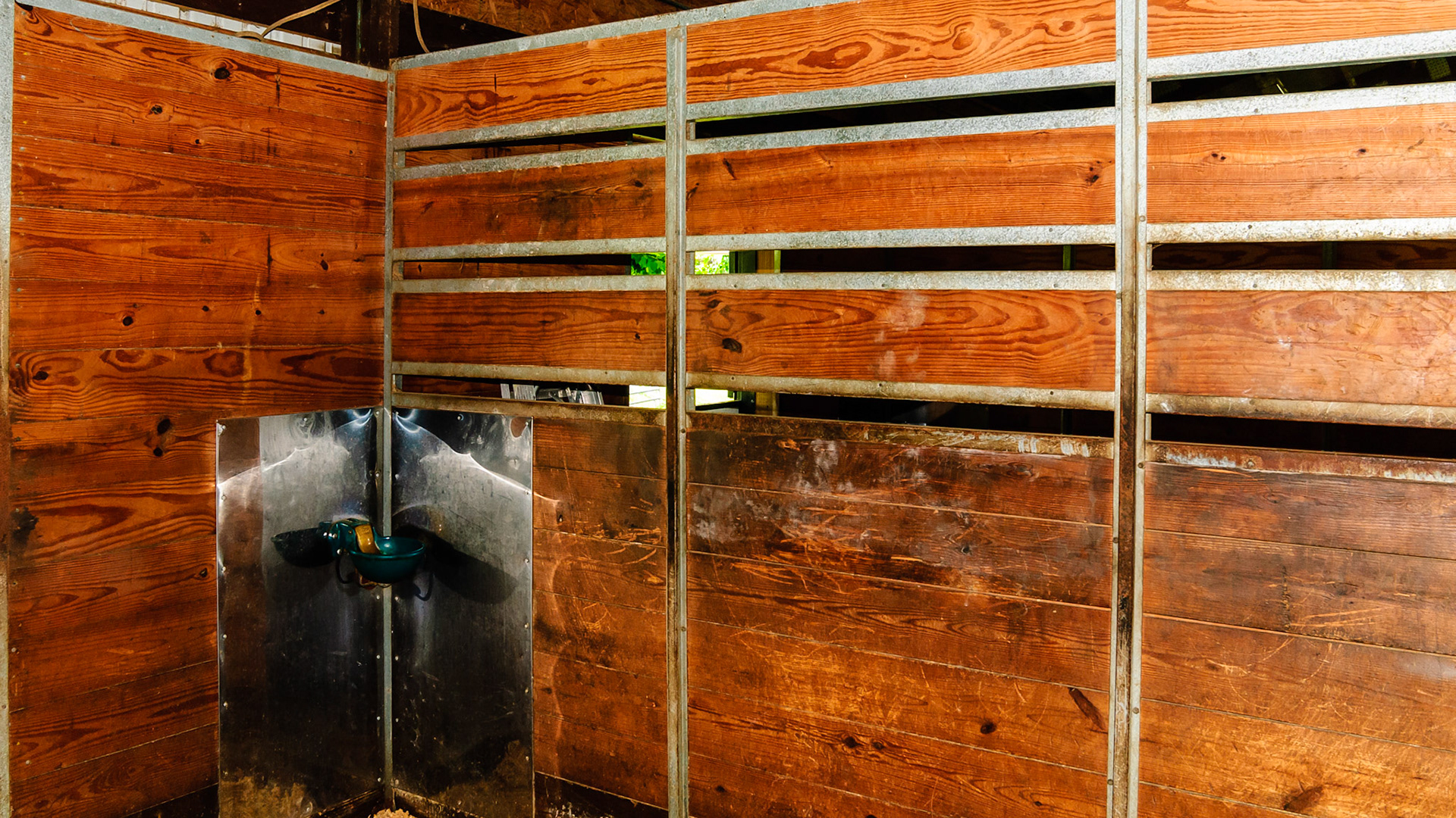 Ribbed metal sandwich plates plus channel metal to protect the exposed board edges.  These usually get rusted and chewed on. The sheet metal behind the water device prevents wood damage and makes easy cleaning of the area.