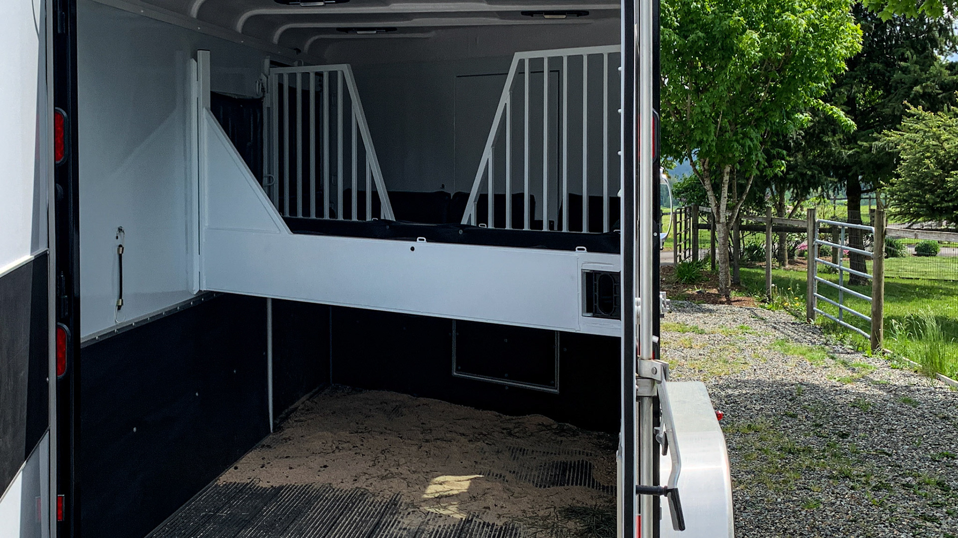 This view shows both dividers in position in this slant load trailer.  The divider between the horses is tall to prevent biting.  Note that a horse can be placed with their heads facing left or right.