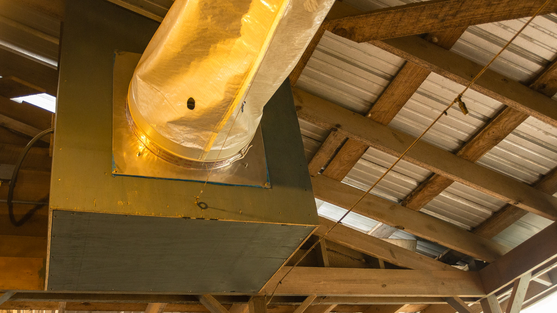 Overhead tube force air ventilatuin system in Alpharetta, GA - it is collapsed because the fan was not on.  This is the fan box that draws air through a roof vent then directs the flow along the roof through the tube.