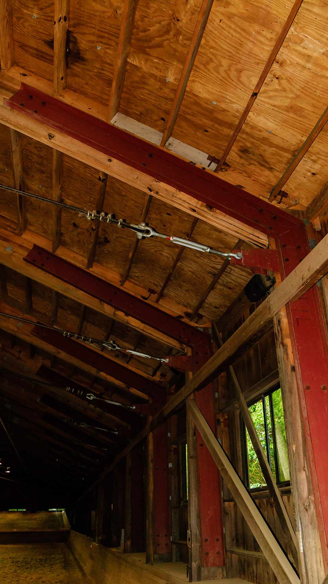 Custom made metal truss braces.  Cabling applied to prevent spread of the walls due to a snow load.