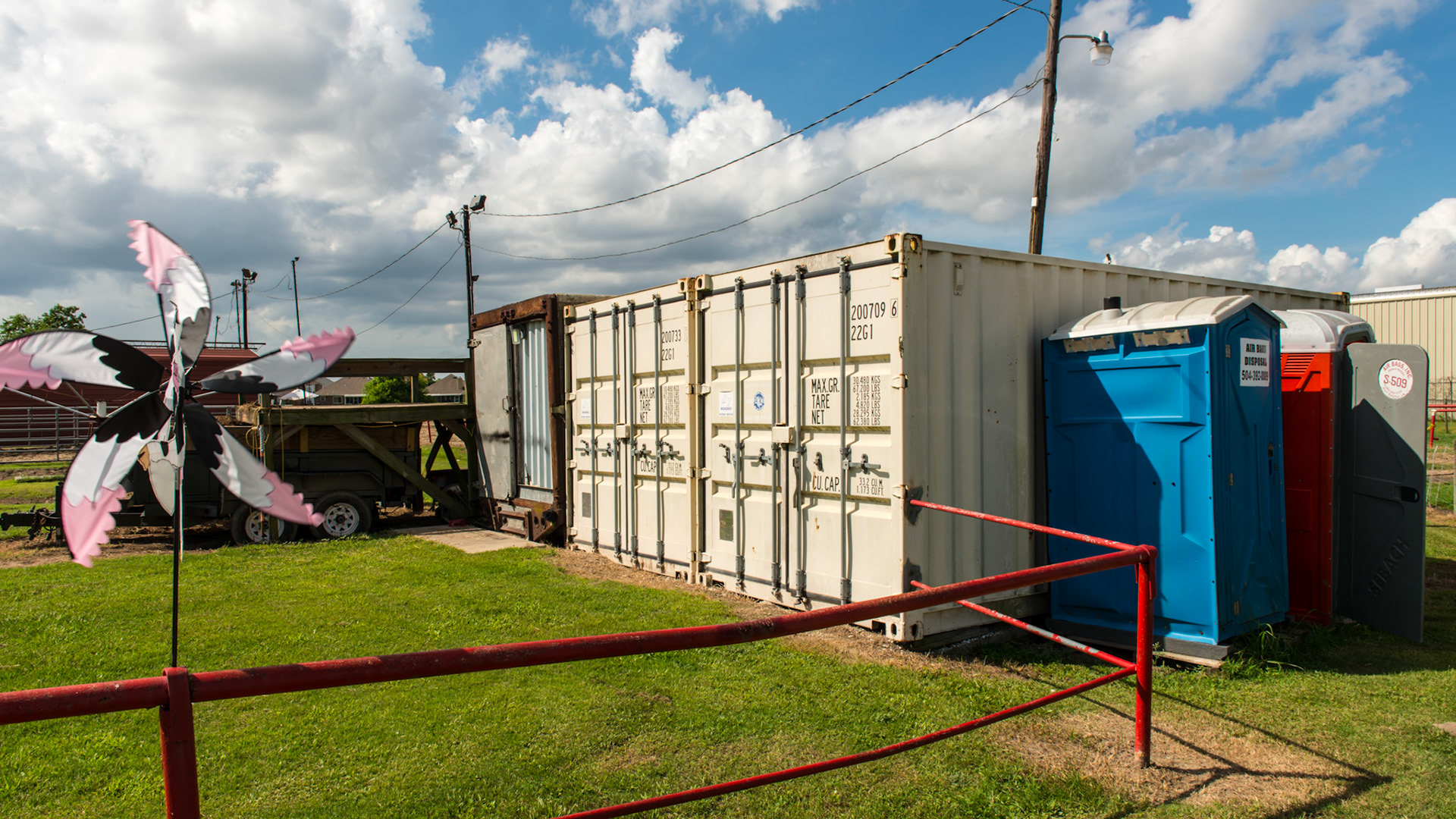 Steel shipping containers store equipment and feed.