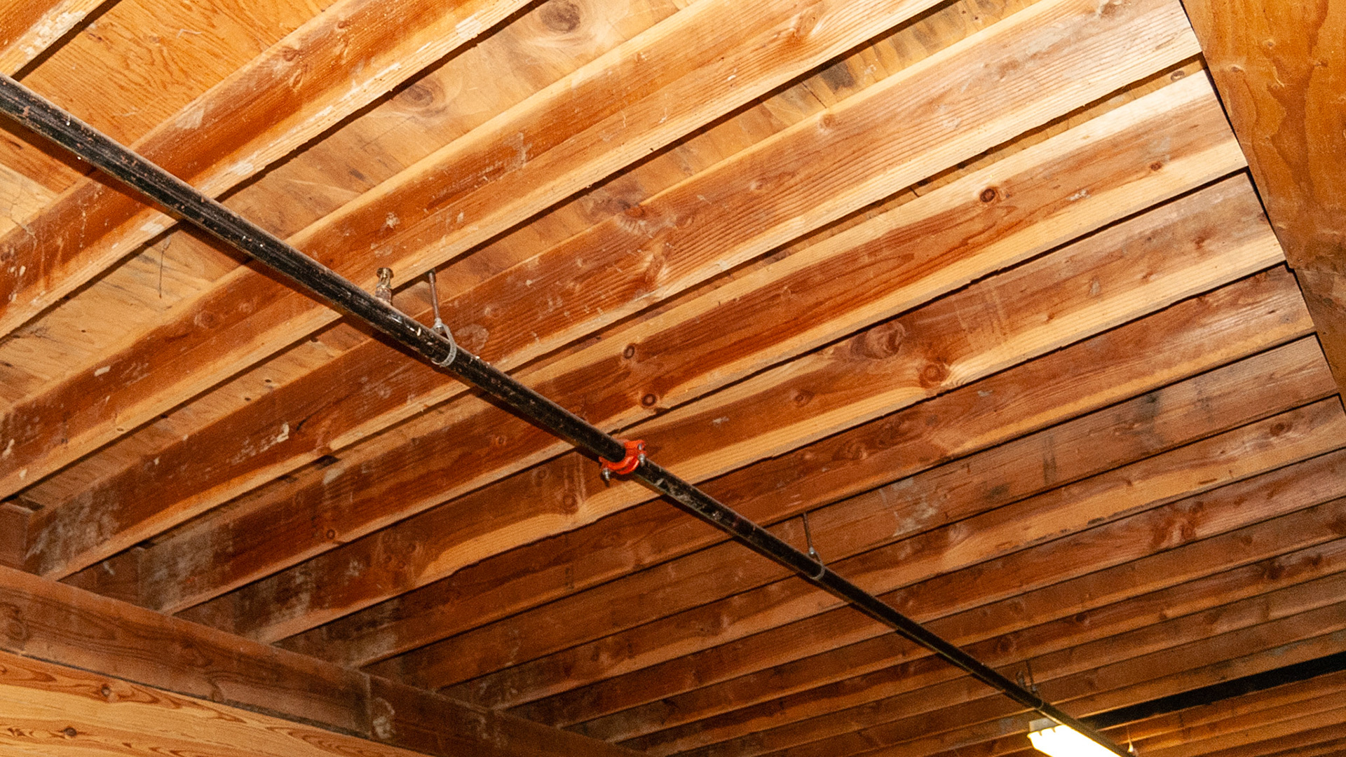 Sprinkler systems inside a barn. Most systems use iron pipe.