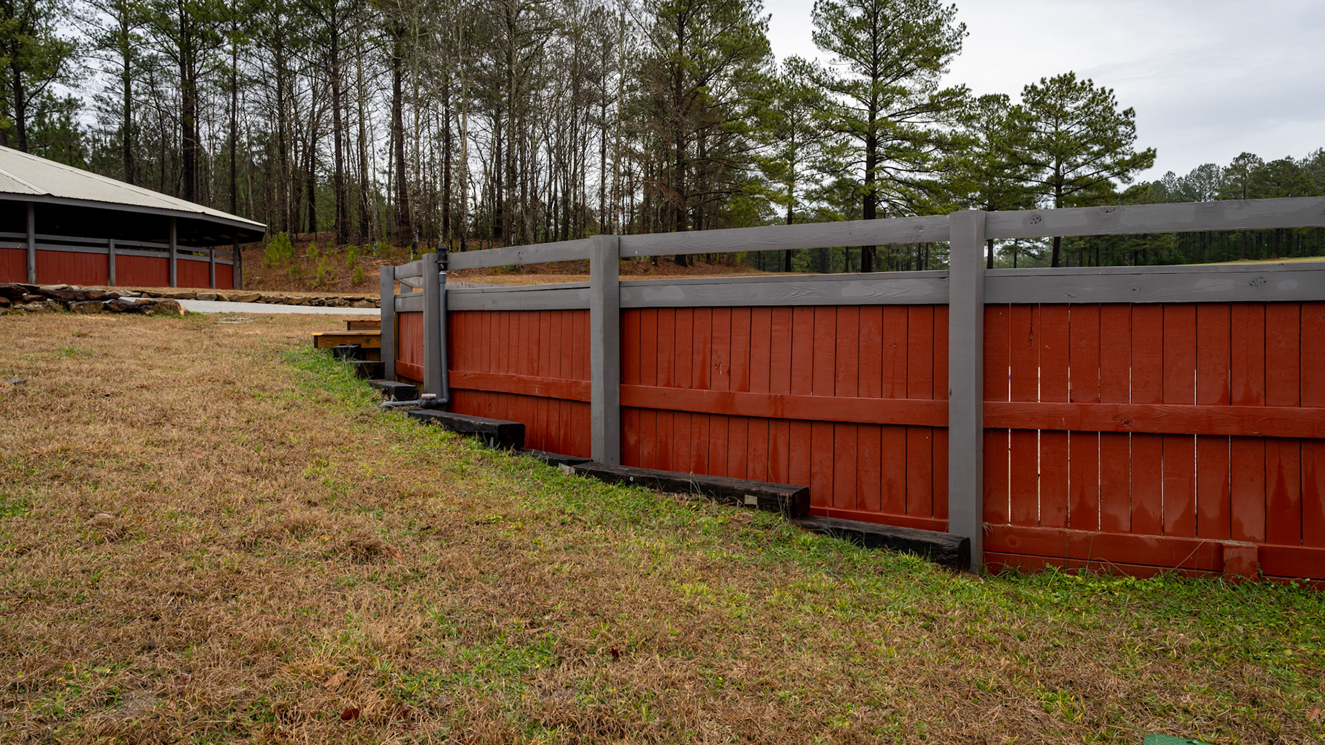 Various views of a round pen built into a hillside.