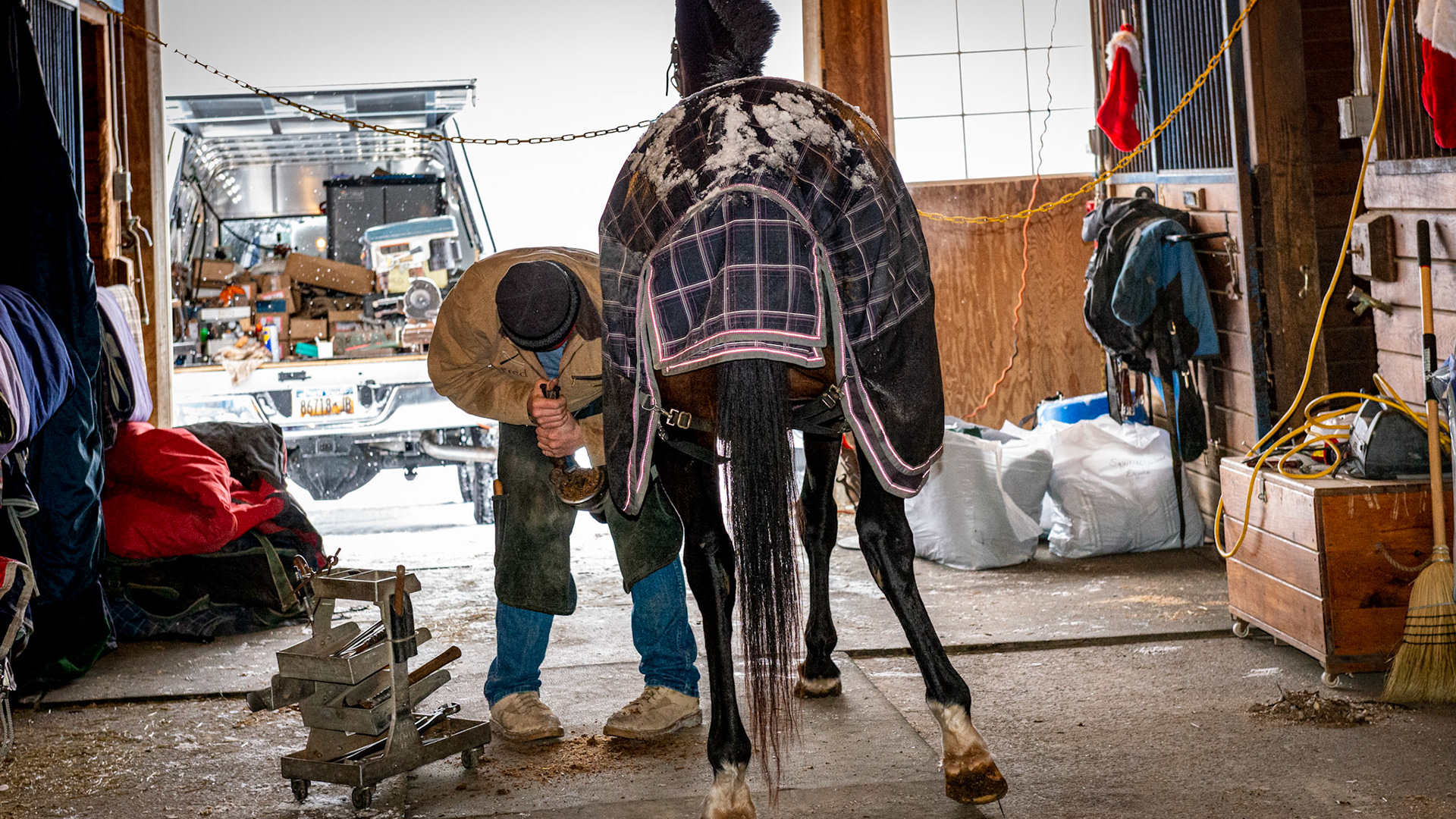 A farrier working on a winter's day.