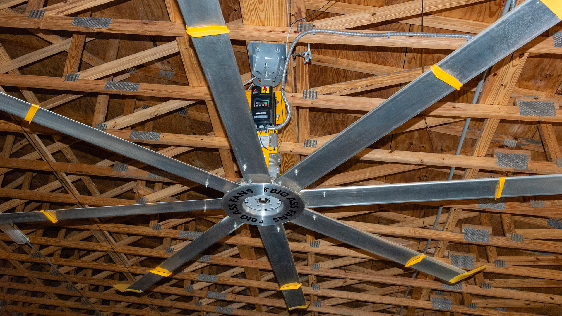 Large volume output ceiling fans created a gentle breeze in this barn keeping the horses cool and flies away.  The roof line was also vented to allow for heated air to escape.