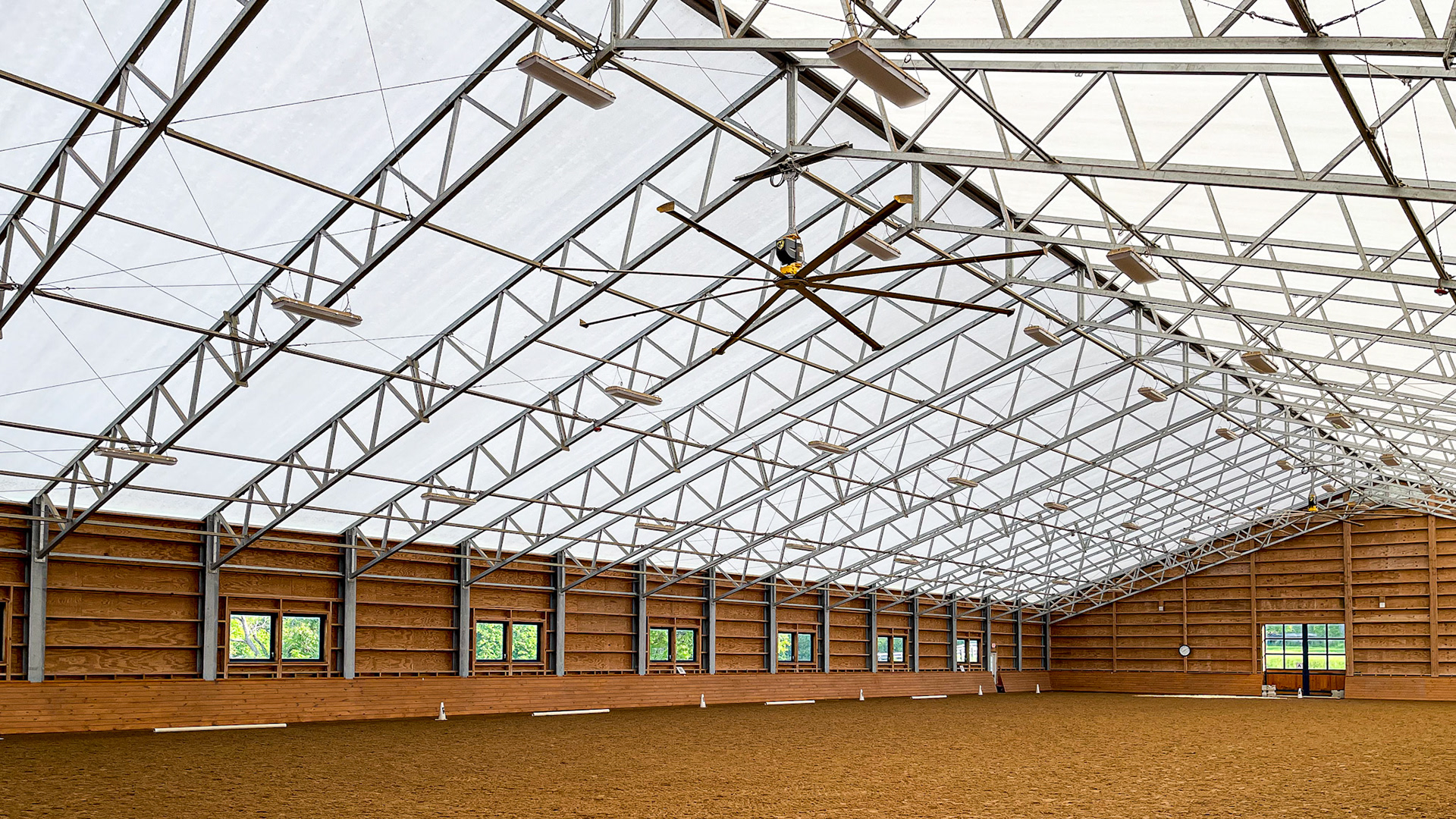 A covered arena using a fabric roof. The stalls are also located within this structure, making winter work more pleasant in central New York.
