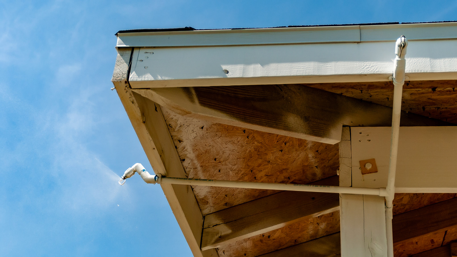 Misting plumbing attached to the roof of an outdoor shed in Florida