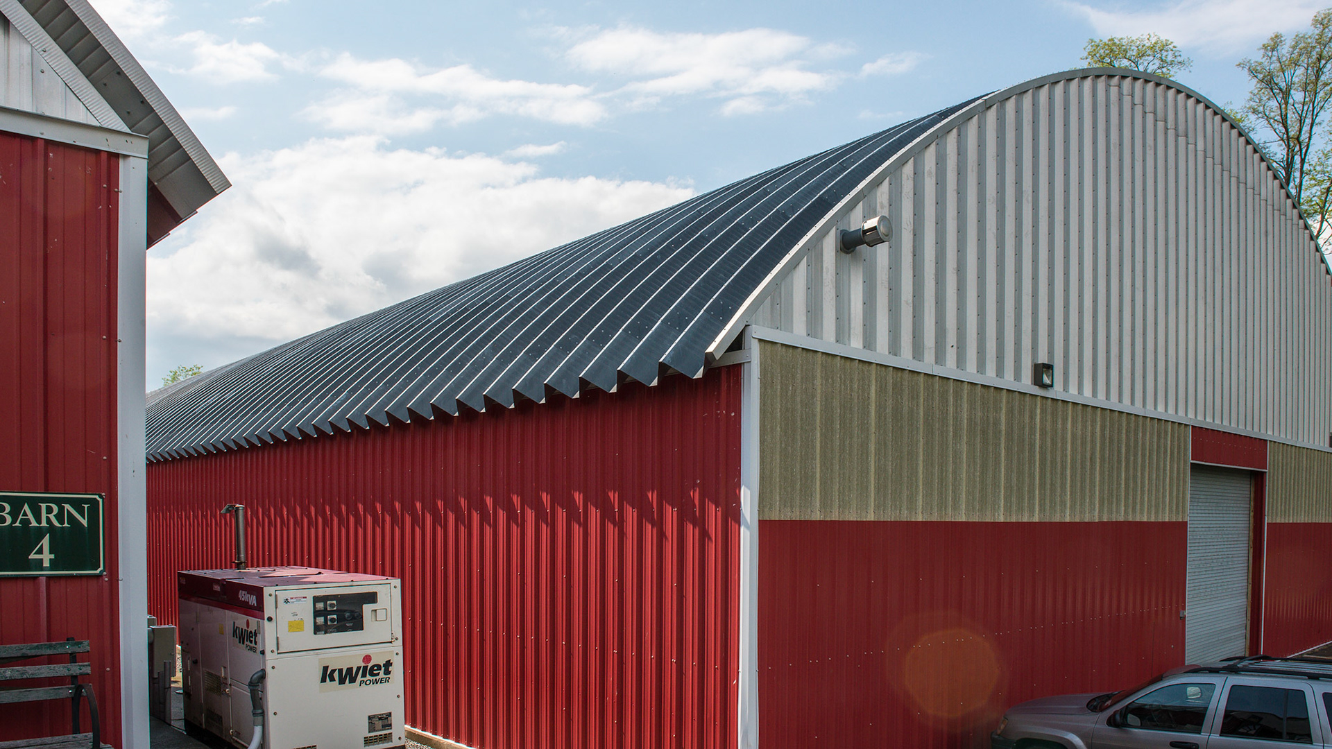 Quonset hut design for the roof of this barn and covered arena. Generator powers the whole barn.