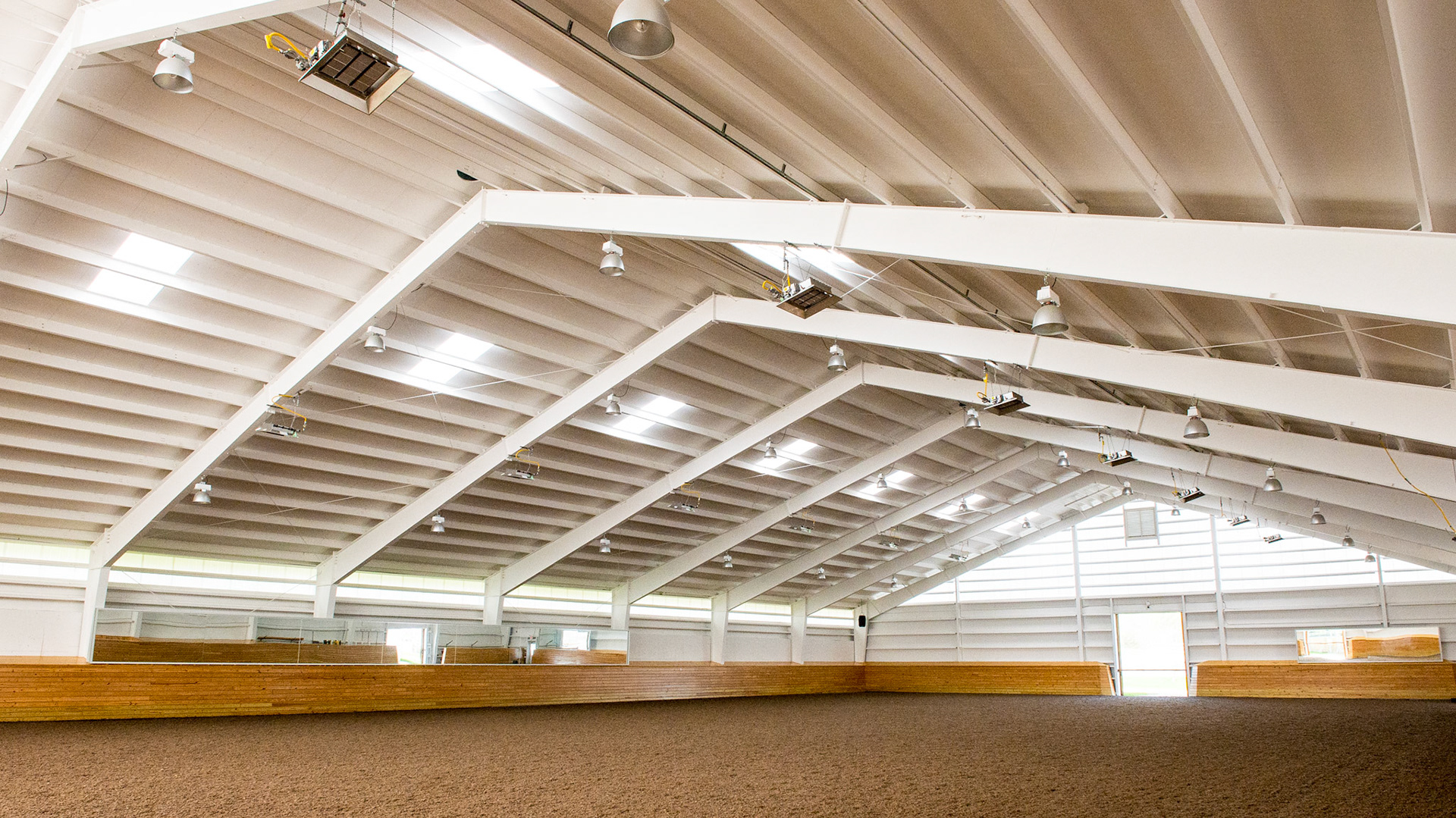 NY indoor arena. Steel clear span, well lit, gas powered heaters.