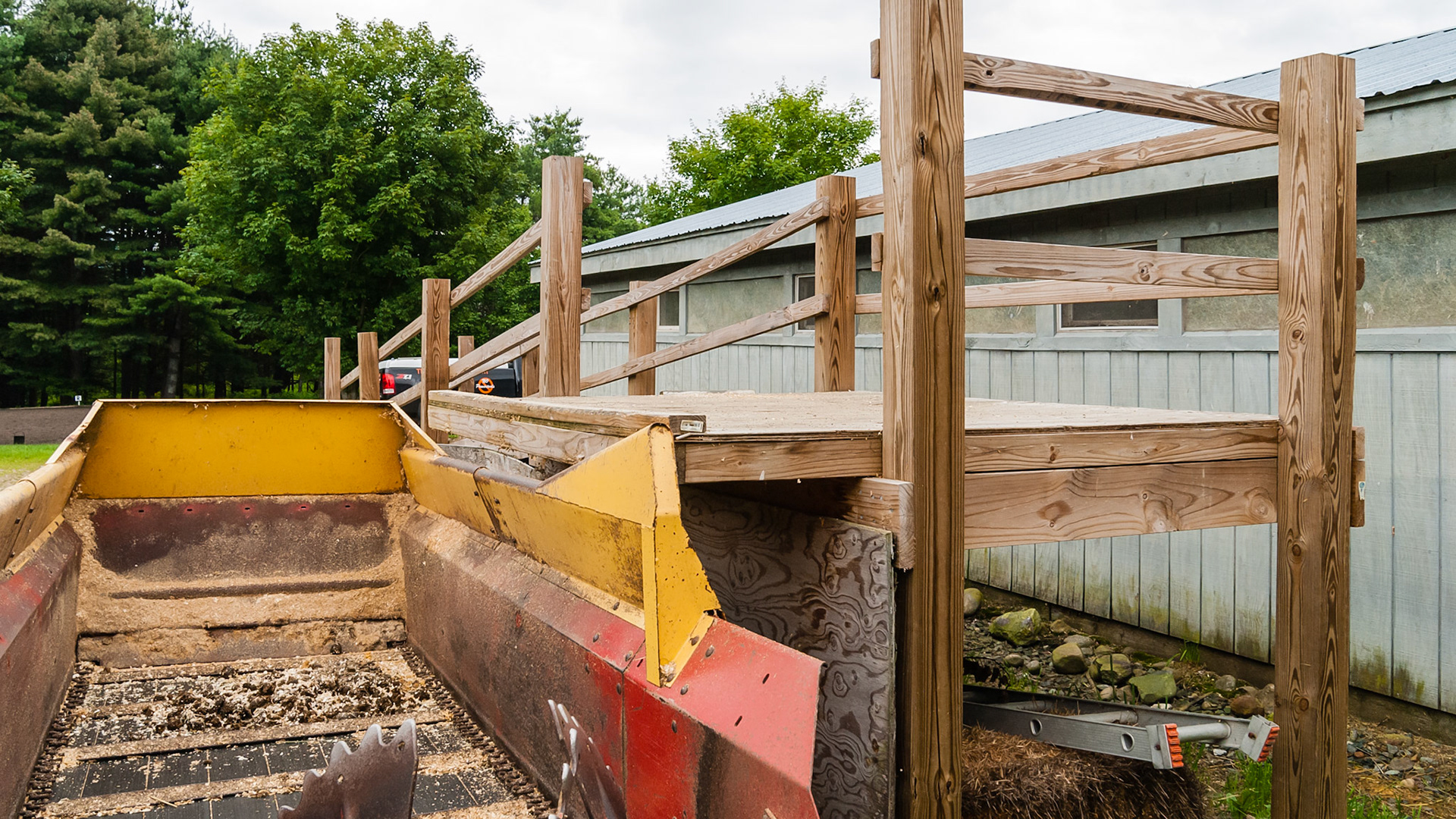 This dumping platform is at a good height and has a bumper to prevent a slight miss but carfeul alignment of the spreader is essential.and snow may raise it too high.
