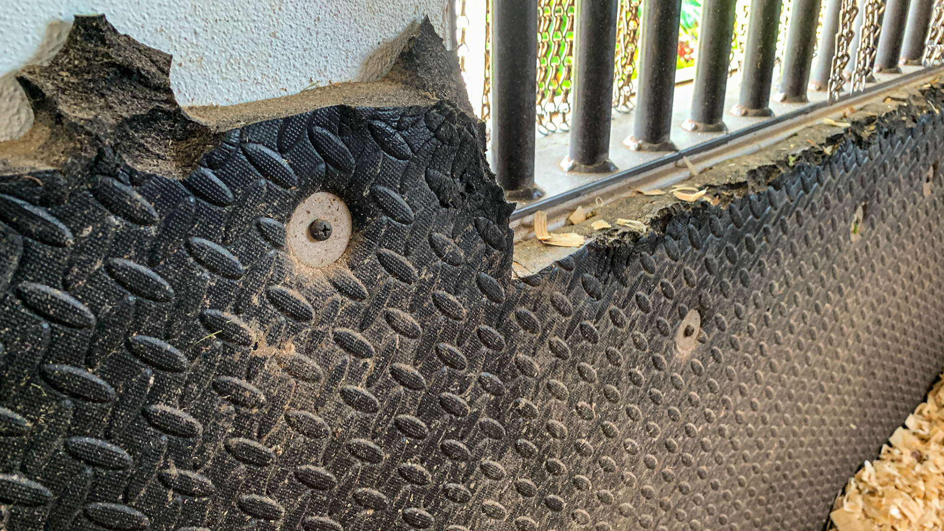 These are thick kick mats securely screwed into the walls.  The scalloped edge is from the tabbed configuration which has become inviting for horses to chew.