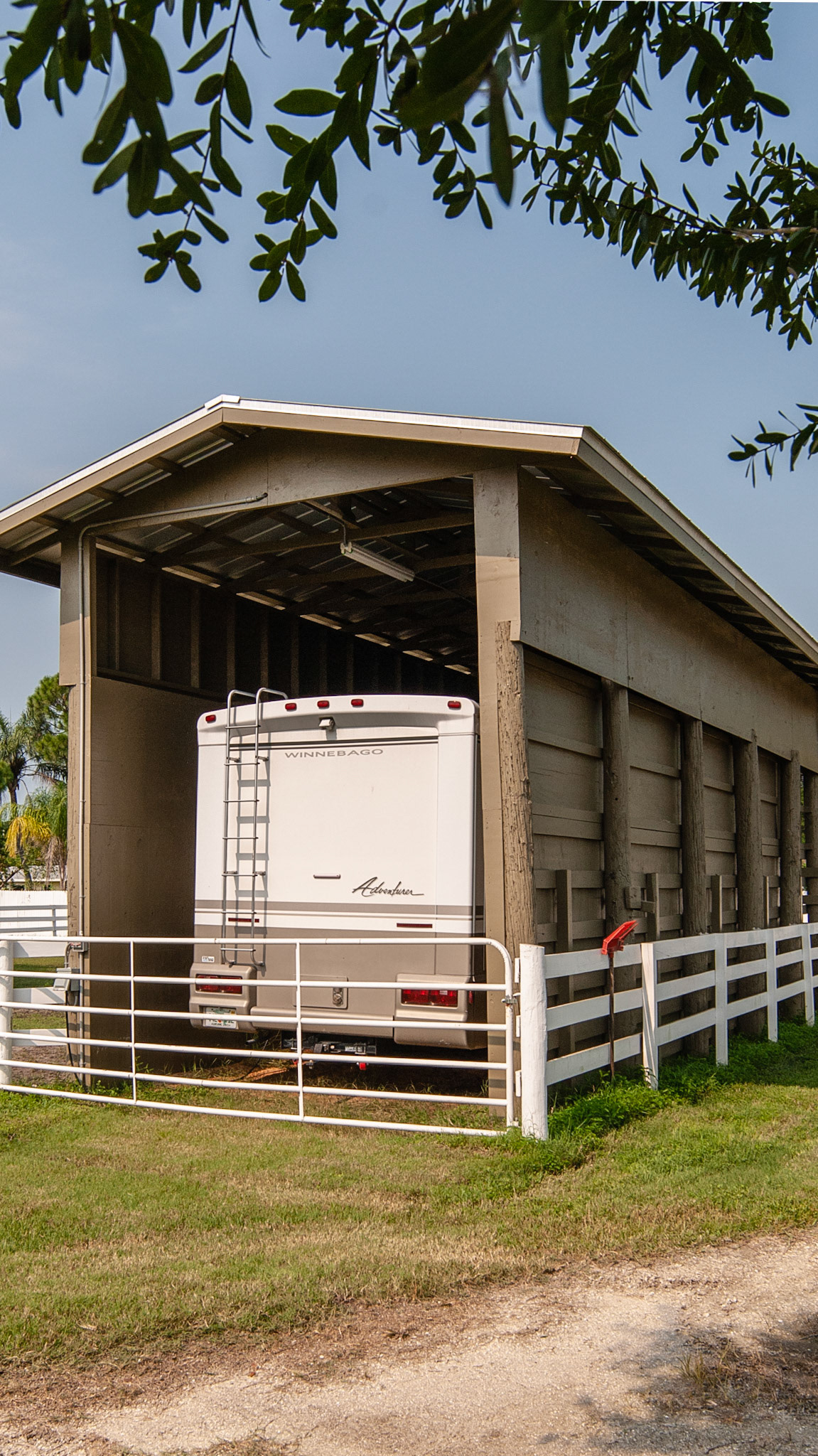 This tall RV shed is built around used telephone poles and is strong against hurricanes.